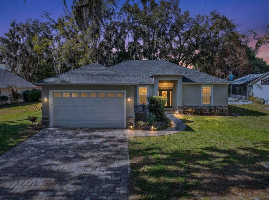 Discover thoughtfully designed living in this modern 4-bed, 2-bath home ideally positioned in charming Eustis with picturesque access to Lake Eustis and a private park just steps away. Built in 2023, this open-concept residence offers 1,744± sq ft of comfortable living space with an inviting floorplan that flows effortlessly for both everyday living and entertaining. 
Step inside to a bright, welcoming living area accentuated by high ceilings, plantation shutters and laminate flooring throughout setting a neutral and stylish tone throughout. The spacious kitchen features quartz countertops, tile backsplash, white shaker cabinetry, a breakfast bar, eat in area, and stainless-steel appliances — perfect for casual meals or gourmet gatherings. 
The generous primary suite boasts a walk-in closet and a private bath with dual sinks and walk in shower. The additional three guest bedrooms offer flexibility for family, guests, or a home office. The guest bathroom offers a tub with shower combination. A convenient laundry room and thoughtful storage solutions enhance daily functionality.
From the living room’s sliding glass doors, you step into a stunning, outdoor retreat designed for year-round enjoyment. The expansive screened lanai features elegant brick paver flooring and covered spaces, creating a seamless extension of the interior living space 
Thoughtfully arranged seating areas offer the perfect setting for both relaxation and entertaining ideal for al fresco meals. Beyond screened room is paver area for more seating with a built in firepit, mature trees, and lush greenery, providing privacy while still embracing the natural surroundings.
Whether enjoying your morning coffee, hosting friends for dinner, or unwinding in the evening breeze, this outdoor living space delivers comfort, charm, and true Florida lifestyle appeal!
The attached 2-car garage and driveway provide ample parking, and the low-maintenance yard offers room for personalization. 
Located in an established neighborhood, this home presents the perfect blend of suburban tranquility and lake-side recreation. With easy access to Lake Eustis, park areas, and community green space, outdoor enthusiasts and boat lovers alike will appreciate the lifestyle this property delivers. 
A great full or part time residence, this home is offered fully furnished.