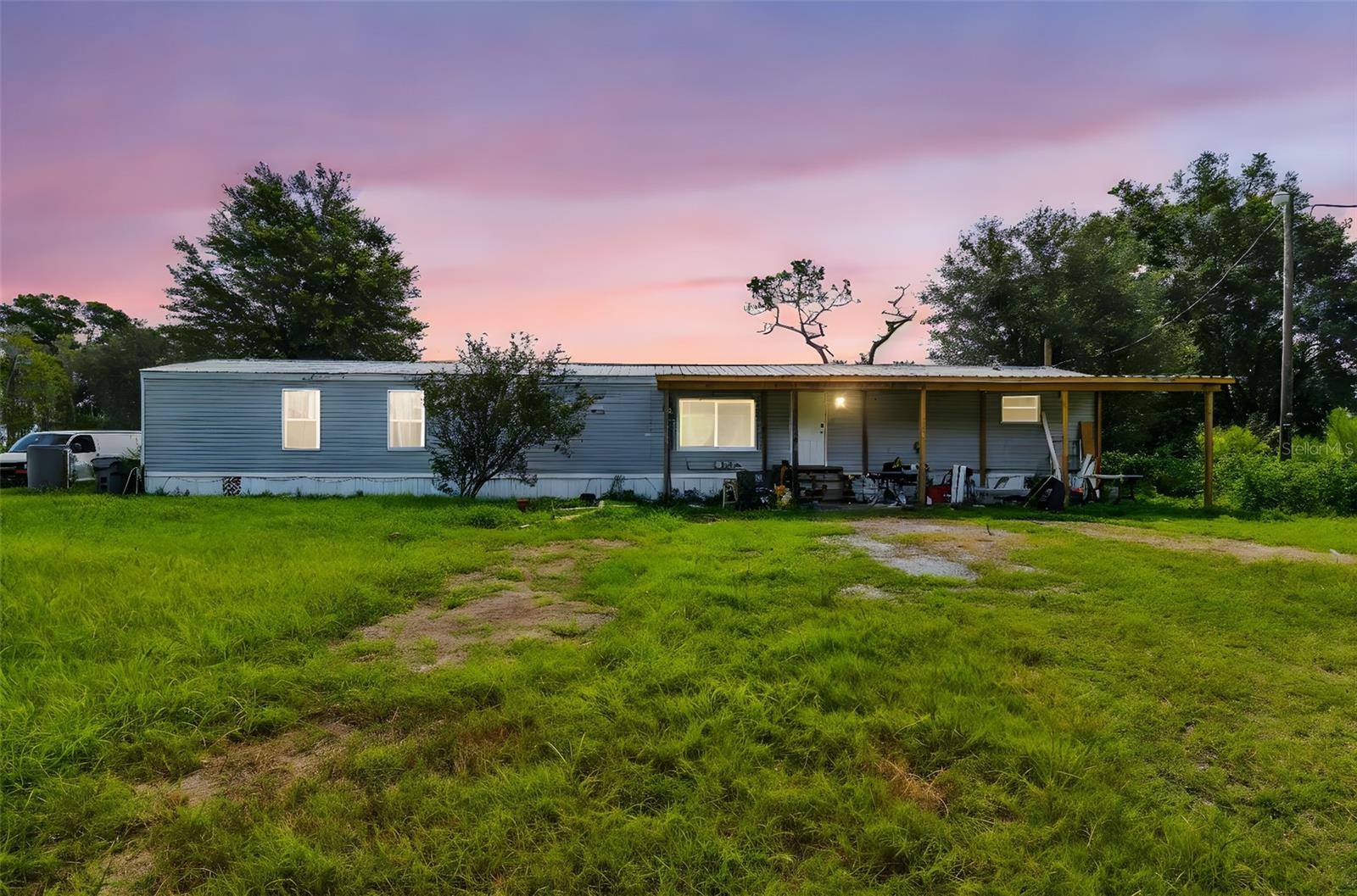 Quiet country living on 5 acres (more or less). Updated Bathrooms and Kitchen. Plenty of room for the family, animals, and toys. Property is fenced with a small stocked pond. You can live in the mobile while you build your dream home - save on those impact fees. The mobile home is a split plan with three bedrooms two baths, inside laundry and newer metal roof. ****Bonus.....Awesome 30x48 barn/workshop for all your needs. The barn does not have water or electric but can easily have it run & installed. .
