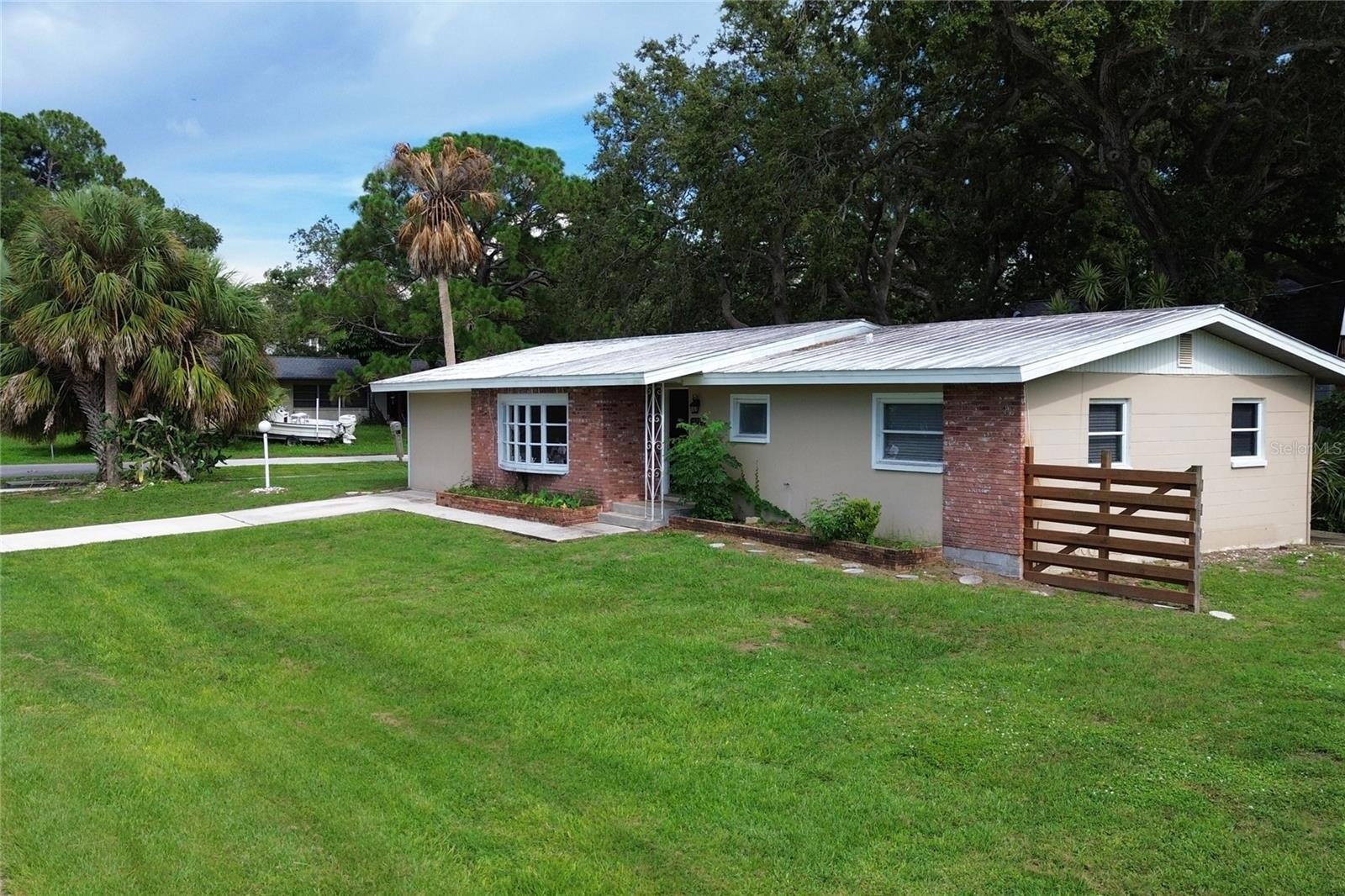 One block from Philippe Park and the water, but not in a flood zone! This home sits high and dry overlooking Tampa Bay, right around the corner from downtown Safety Harbor with its fantastic restaurants and eclectic shops. The backyard oasis on this property is breathtaking with towering oak and palm trees, a tall privacy fence, a fire pit, a grilling area and a storage shed. This is one of the best deals on the market for this location at this price.