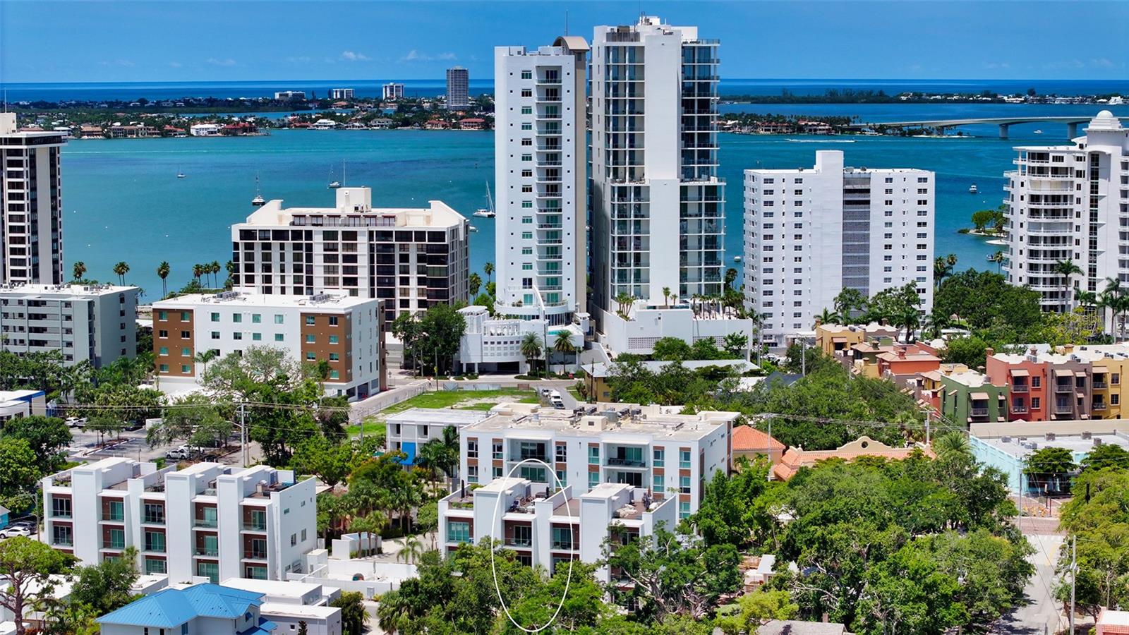 Sophisticated urban living awaits in this refined three-story townhouse with a PRIVATE ELEVATOR and expansive ROOFTOP DECK, located in the exclusive Townhomes of Orange Club in downtown Sarasota. Just steps from the historic Burns Court district and the city’s vibrant Bayfront, this stylish residence offers 2,300 SF of thoughtfully designed living space, including 3 bedrooms each with their own ensuite bathroom. The private rooftop deck is a true sanctuary featuring a jacuzzi hot tub, outdoor kitchen, privacy wall, and 608 SF of additional outdoor living space – perfect for relaxing or entertaining under the stars, all with captivating city views. Designer finishes throughout, soaring 10-ft smooth-finish ceilings, Low-E impact windows and doors, contemporary baseboards and casings all enhance the home’s clean aesthetic. A private two-car garage opens to a welcoming foyer and a guest bedroom with ensuite bath on the first level. The second floor is designed for effortless entertaining, with an open-concept great room, east- and west-facing balconies with frameless glass railings for unobstructed views, powder room, and a gourmet kitchen featuring imported Italian cabinetry, quartz countertops, and Jenn-Air stainless steel appliances, including a six-burner gas range. Upstairs, the third floor hosts a serene primary suite and a spacious second bedroom, both with ensuite baths and private balconies. A laundry closet with full-size washer and dryer adds convenience. Residents of Orange Club enjoy a secure, upscale community with surveillance cameras, a heated pool, and a sun lounge area. Located in the heart of Sarasota, you’re just moments from the city’s best, including a thriving arts and culture scene, award-winning dining, boutiques, nightlife, farmers market, and year-round festivals. This is downtown Sarasota living at its finest.