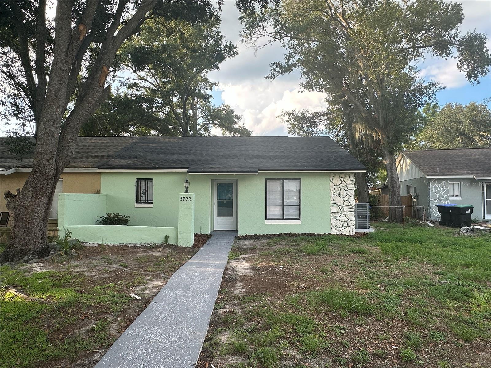 Completely renovated and move-in ready, this home is perfect for a first-time homebuyer or savvy investor. The redesigned kitchen is a chef’s dream, featuring new white shaker cabinets, granite countertops, and a stainless steel appliance package. Freshly painted inside and out, the home showcases new vinyl flooring throughout, remodeled bathrooms, and vaulted ceilings with skylights that brighten the living space. Major upgrades include a 2024 roof and 2025 A/C system for peace of mind. Relax in the screened patio or enjoy the oversized fenced backyard—ideal for gatherings and sunny Florida days. Conveniently located near schools, banks, dining, and shopping, with easy access to major highways and just under an hour to all the theme parks. Schedule your private tour today!