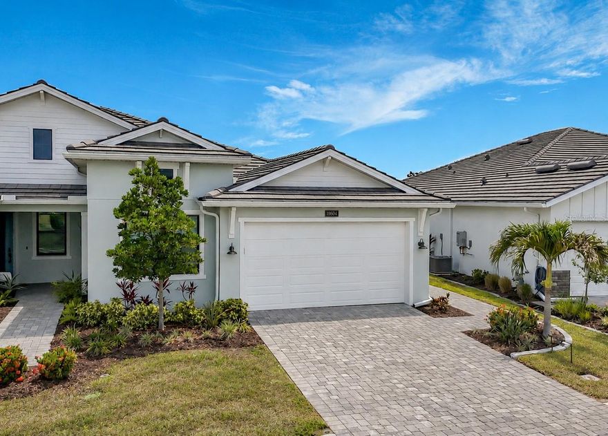 Luxury finishes, exceptional storm protection, outstanding energy efficiency, and a private outdoor setting combine to make this one of the most desirable villa offerings in Wellen Park! Welcome to 18604 Dayspring Place, an impeccably upgraded Toll Brothers "Dunnet" floor plan in the highly sought-after Solstice neighborhood. Offering the spacious feel and privacy of a single-family home with the ease of low-maintenance villa living, this elegant home features 3 bedrooms, 2 baths, a 2-car garage, and 1,795 square feet of thoughtfully curated living space. Designed for both comfort and peace of mind, the home features impact windows, a concrete tile roof, "Storm Smart" powered hurricane screens enclosing the lanai, and the coveted Flood Zone "X" designation. Inside, soaring volume ceilings, 8-foot doors, tray ceilings in the great room and primary suite, and abundant natural light create an open and airy atmosphere. At the heart of the home, the gourmet kitchen is impeccably appointed with quartz countertops, crisp cabinetry, beveled tile backsplash, natural gas cooktop, stainless steel vent hood, wall oven and microwave, upgraded KitchenAid appliances, pull-out lower cabinet shelves, and an extended 64-inch-wide pantry - a one-of-a-kind addition to this home! The open-concept design connects all living spaces, creating an ideal setting for both everyday living and entertaining. Refined enhancements elevate the interior, including plantation shutters, upgraded LED pendant lighting, recessed lighting, designer LED chandelier, premium ceiling fans in every bedroom, and Hunter Douglas window treatments throughout, including a sleek 'Vertiglide' shade on the sliding door. The luxurious primary suite offers a spa-like bathroom with a dual-sink quartz vanity, oversized walk-in shower with frameless glass door, and an extraordinary walk-in closet featuring additional shelving and double hanging racks for optimal organization. A rarely found feature in paired villas is the fully fenced backyard, creating a private outdoor sanctuary. The screened lanai, expanded landscape beds, and lush tropical garden island provide the perfect setting to enjoy year-round outdoor living. Additional enhancements include tile flooring throughout the main living areas and engineered hardwood flooring in all bedrooms (no carpet anywhere)! The laundry room is outfitted with an upgraded LG washer & dryer, added cabinetry, and a dedicated exhaust fan for enhanced air circulation. An expanded HVAC closet provides valuable added storage space unique to this home. The garage is equally impressive, featuring an epoxy-coated floor, insulated garage door, added shelving, and upgraded R-38 insulation throughout the entire attic (including above the garage) providing exceptional energy efficiency and year-round comfort. Located within one of Southwest Florida's premier master-planned communities, Solstice residents enjoy convenient access to Downtown Wellen Park, boutique shopping, waterfront dining, entertainment, miles of trails, parks, the Gulf Coast's renowned beaches - all just a short bike ride or golf cart ride away. Reasonable fees provide access to a resort-style pool, fitness center, pickleball courts, clubhouse, lawn care, irrigation, annual mulch, and internet with basic cable, supporting a low-maintenance, luxury lifestyle. This exceptional residence offers a rare opportunity to enjoy elevated Florida living in one of Venice's most desirable destinations!