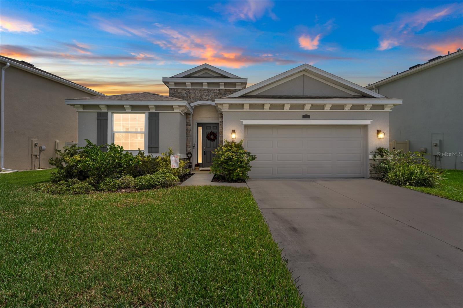 This one-story, all-concrete block home offers an open concept floor plan with a spacious kitchen overlooking large living and dining areas that flow seamlessly to a covered lanai—perfect for relaxing or dining alfresco. Two bedrooms share a full bath at the front of the home, with a fourth bedroom (optional den) and powder bath nearby. The private owner’s suite is tucked at the back with an en-suite bath. The home includes a stainless-steel dishwasher, range, and microwave.
Located in an incredible community with a 7.5-acre man-made lagoon, you’ll enjoy a true Florida lifestyle—swim, kayak, paddleboard, or relax on the sandy beach. Weekly events like football watch parties, cigar nights, and beach festivals make every day feel like vacation. Residents also enjoy dog parks, playgrounds, and volleyball courts. Conveniently golf cart accessible, you’re just minutes from the lagoon, Publix, Starbucks, Chick-fil-A, and more!