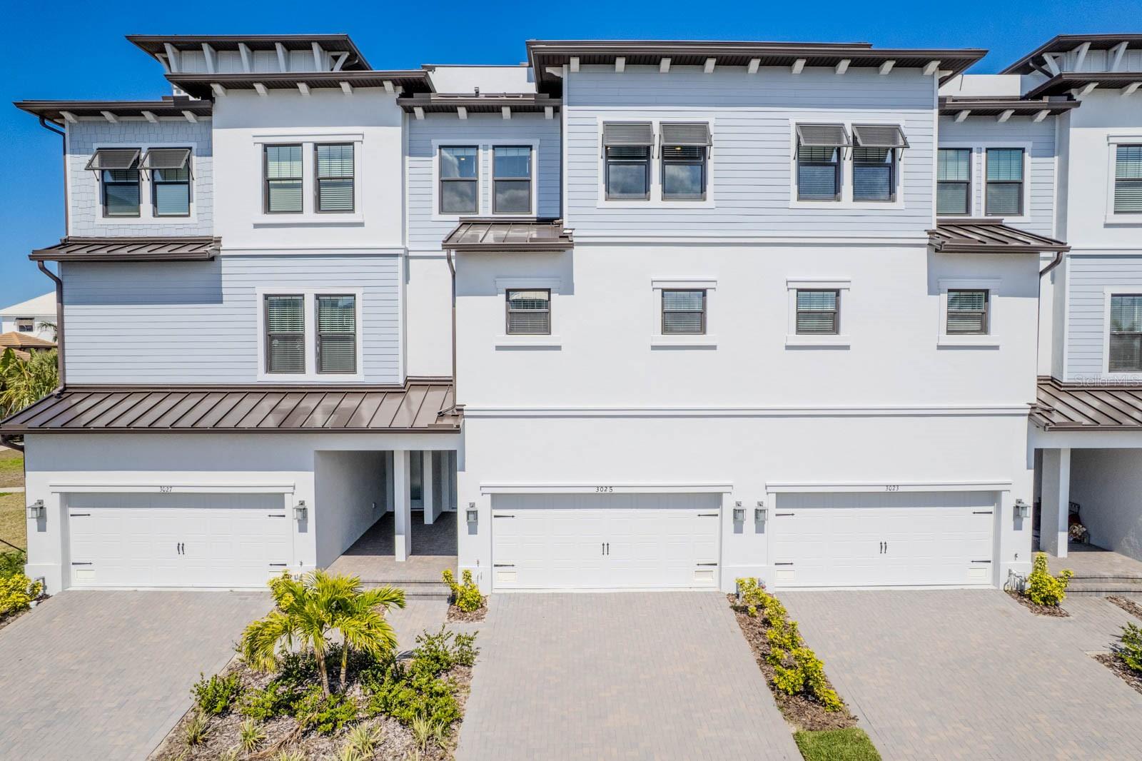 WATERFRONT VIEWS AND BEAUTIFUL SUNSETS can be enjoyed from the 4TH STORY PATIO of this BRAND NEW Townhome in the exclusive South Shore Yacht Club Community. This four-story townhome features a PRIVATE ELEVATOR for your convenience. As you enter the home from the covered patio, the first floor consists of a large room that could be used for an entertainment/game room, full bathroom and bedroom. The second floor has a large open kitchen, dining and family room, and a covered porch and balcony. The third level hosts all three bedrooms and a full size laundry room. The top level has a large roof deck for entertaining with beautiful water and city views!! The community offers resort-style amenities! For boaters, there is a FULL-SERVICE MARINA WITH DEEP-WATER ACCESS and an awesome clubhouse. The private clubhouse offers billiards, lounge areas, and a beautiful pool overlooking one of the two marinas. Little Harbor is a boater's paradise with a sandy beach, two on-site restaurants, basketball and pickleball courts, and a fitness center.