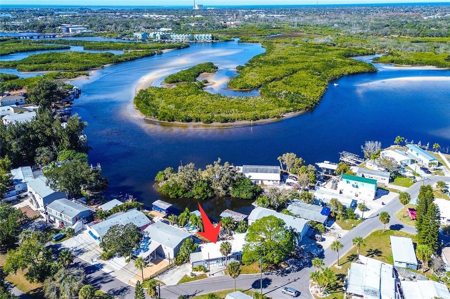 FULLY FURNISHED Turnkey, Perfect for AIRBNB/Vacation rental or Retirement living! ANCLOTE RIVER WATERFRONT PROPERTY with Direct Access to GULF OF MEXICO! With DOCK! NO FLOODING during storms. Manufactured Home. PRISTINE INTERIOR REMODELED by owner/contractor. Spacious 3BR PLUS Home Office. GARAGE plus 3 DRIVEWAYS, parking for 8-10 vehicles. Bring your boats, trailers, jet skis, golf cart, Harley, Room for ALL YOUR TOYS! After a day of boating drive right up onto your New private floating dock "wave armor" brand, can hold up to 22-28 ft. boat. You can go out during low tide approximately 2 ft. of water. Living on Florida’s nature coast, enjoy the wildlife and waterfowl including dolphins, otters, manatee! Walk 200ft to Pinellas Trail, walk to Pickleball courts. All with NO HOMEOWNER FEES, OWN YOUR OWN LAND. No lot fees. Enjoy this home in this tropical, peaceful, serene, quiet setting. Close to world famous Tarpon Springs Sponge Docks and Downtown Tarpon Springs that offers many restaurants and shops. Drive up to Rusty Bellies waterfront restaurant for lunch. Short ride to the Gulf. Close to everything in Tarpon Springs - Sunset Beach and Howard Park Beach. This home has LOTS OF IMPROVEMENTS – Stunning kitchen with Center Island, quartz countertops and plenty of cabinets and new LED lighting. NEW HVAC system, new water heater, New wood laminate flooring throughout, new lighting and fans, newer stainless steel appliances, newer windows, remodeled bathroom. 3 bedrooms and 2 full baths with a bonus room that can be used for an office, play room, craft room etc. also a Florida room with a window air conditioner that overlooks water. Home is also equipped with water softener and reverse osmosis system. Primary suite with wainscoting adding charm and a beach vibe. Dual sinks in hall bath. Walk out back and enjoy your view from the screened lanai or wood deck where you can watch nature at its finest. Come today and start living the Florida lifestyle! FULLY FURNISHED for a Turnkey VACATION RENTAL!