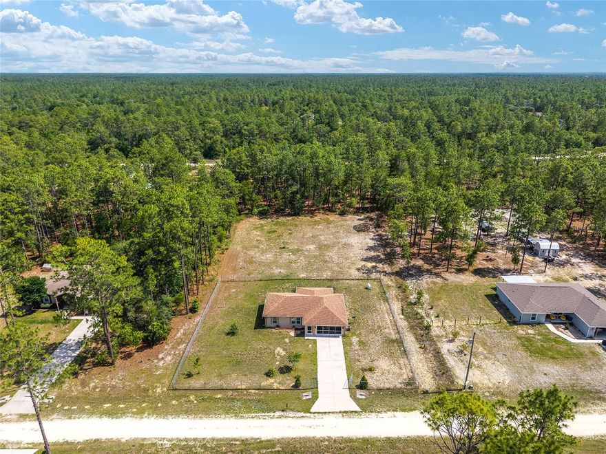 Where the Good Life Grows — Built in 2018 and tucked away on a 1.16-acre parcel, this home is settled between the gentle rhythms of Dunnellon and the vibrant energy of Ocala.  This charming 3-bedroom, 2-bath home with a 2-car garage sits on an open canvas of possibility in the peaceful Rolling Hills community — where the sky stretches wide, the neighbors are spread out, and the living is gloriously unhurried.
Picture your mornings here: coffee in hand, a soft breeze drifting across your very private backyard, and enjoy the kind of quiet that doesn't exist in the city. This is the property where your mini farm dream finally takes root — raised beds, fruit trees, or chickens — all the things your heart has been waiting to tend. There's room to breathe, room to grow, and room to simply be.
And when the farm call for a rest day? The legendary Rainbow River is just minutes away, waiting to carry you along its crystalline, spring-fed waters on a lazy float that feels like something out of a postcard. Or gather the boat and head out to the Withlacoochee River or Hernando and Inverness chain of lakes, where a full day on the water, and maybe a little fishing, resets the soul like nothing else can.  Come evening, the choice is yours — dinner and live music in the charming shops and restaurants of Crystal River, or a night out in the heart of Ocala, with its thriving arts scene, dining, and entertainment. Both are an easy, scenic drive away. This is the rare kind of property that offers it all without asking you to compromise — wide open spaces and central convenience, rural charm and weekend adventure. Whether you're planting seeds or planning your next river day, Rolling Hills is ready to welcome you home. Centrally located between Dunnellon and Ocala. Minutes to the Rainbow River, World Equestrian Center, Crystal River, and the Hernando/Inverness lakes.