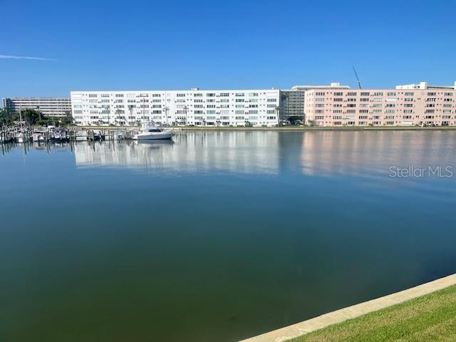 Watch the dolphins play, Manatees swim by and all the Florida fish and birds from your Florida Room. This is one of the few units with this much square footage for a one bedroom, 1060 SF. Beautiful Sunsets, walk to the beach and all the community has for its owners Updates throughout. New refrigerator (2025), never used. New storm door installed 2025. HVAC 2018. Carport is #17. Hardwood floors through out & painted concrete in the Florida Room. Room divider in the oversized living area, could be used as a second bedroom. Full laundry on the 2nd floor. Enjoy the restaurants and quaint shopping community, art walks, markets and more. The community itself has multiple pools, clubhouse, fitness classes and tennis courts, fishing and marina. Approx. 5-10 minutes to St Pete Beach or 5-10 minutes to Downtown St Petersburg, easy access to Skyway Bridge, Ft Desoto and the interstate to commute to Tampa airport.