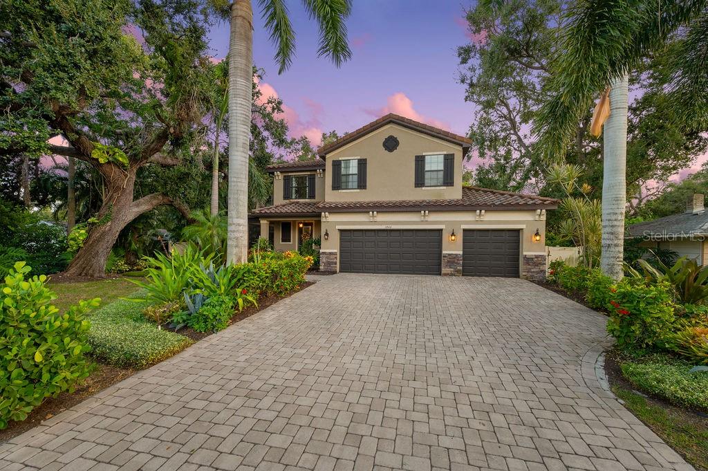 This newer West of the Trail residence combines timeless sophistication with modern upgrades and a thoughtfully designed floor plan. The spacious great room flows effortlessly into the kitchen and dining areas, creating the perfect setting for both relaxed daily living and elegant entertaining. The chef’s kitchen is appointed with granite countertops, rich wood cabinetry, stainless steel appliances—including a newer refrigerator—plus a center island, breakfast nook, and walk-in pantry. The adjoining dining area connects seamlessly to both the kitchen and great room, while upgraded light fixtures, ceiling fans, and window treatments enhance the home’s refined interior.
Upstairs, warm acacia wood flooring begins at the staircase and continues throughout, setting a stylish tone. A versatile bonus room offers endless possibilities—an office, media lounge, or playroom—and is centrally positioned between split-plan bedrooms. The bathrooms and laundry room, complete with a newer washer and dryer, feature luxurious travertine tile. Every closet, including the pantry, has been outfitted with custom cabinetry and shelving for optimal organization. Comfort and efficiency are further elevated by the 2025 A/C system with Micropure air purification, a Honeywell filter rack, and UV light technology.
The crown jewel of this home is an extraordinary $300,000 addition, seamlessly integrated with a full tile roof and new foundation to create a showstopping indoor-outdoor living experience. Designed for entertaining, the expansive space boasts soaring vaulted ceilings, a two-sided ethanol fireplace, and a dining area anchored by a full custom outdoor kitchen. This impressive kitchen features a bar with seating, designer hood, four refrigerators, an ice maker, sink, and garbage disposal. Dual-zone surround sound enriches both the dining and bar areas, while an automatic screen system allows you to transition effortlessly between a screened retreat and an open-air oasis. Expansive artificial turf completes the setting, offering year-round beauty and low-maintenance green space.
The solar-heated pool and fully fenced backyard provide a private sanctuary. In 2025, the owners invested an additional $15,000 in professional landscaping and a new sprinkler system, further enhancing the grounds.
Perfectly located near the highly desired Southside elementary school, this home is within walking distance of Southside Village and Sarasota Memorial Hospital. With Siesta Key’s north bridge and downtown Sarasota just minutes away, this residence offers an exceptional lifestyle where luxury, comfort, and convenience converge.