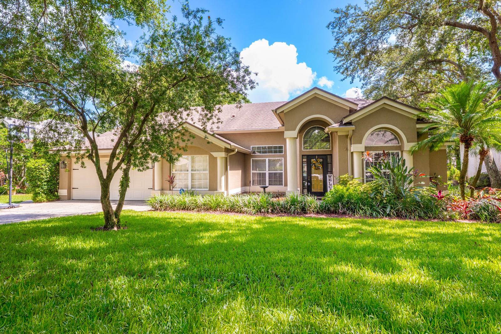 This property QUALIFIES FOR A CREDIT UP TO $10,125 through the seller's preferred lender ***Welcome to the Villages at Kingsbridge West – one of Oviedo’s top communities where lifestyle, location, and livability come together on a serene .37 ACRE CUL-DE-SAC LOT! This light filled POOL HOME delivers standout curb appeal, mature landscaping, and an expansive private feel, all in the heart of Oviedo with easy access to TOP-RATED SCHOOLS, shopping, dining, UCF, and major highways. Step inside and be greeted by vaulted ceilings, an OPEN & VERSATILE LAYOUT, and easy care TILE & WOOD FLOORS - no carpet here! Formal living and dining spaces are balanced by relaxed family areas, including a spacious kitchen that truly shines with NEWER STAINLESS STEEL APPLIANCES (2023), ample cabinetry, pantry storage, and a casual dining space with views of the pool and backyard. A charming arched doorway leads to a wet bar and the formal dining area, ideal for entertaining! The oversized COVERED LANAI extends your living space outdoors and overlooks your sparkling PRIVATE POOL and lush landscaping, all screened for maximum comfort. There is even a convenient POOL BATH to keep wet feet out of the house! A generous PRIMARY SUITE is thoughtfully positioned on one side the home with DUAL WALK-IN CLOSETS, a well appointed en-suite bath and access to a second bedroom - perfect for a nursery, home office or cozy retreat. Two additional bedrooms, spacious living areas, and tons of natural light make this floor plan adaptable for your lifestyle now and into the future. ***UPDATES INCLUDE: new PLUMBING (2019), a NEW WATER HEATER (2025), NEW POOL PUMP (2025), RESURFACED POOL & NEW TILE (2022), leaf filter gutter protection and new front gutter (2022), and the roof and A/C were both updated in 2012. Inside and out, everything feels well maintained and current! Kingsbridge West residents enjoy great amenities that include a community playground, tennis courts, and a dock on scenic Long Lake. Plus, there is a walking path that connects to Oviedo on the Park – adding even more fun, food and festivities to your everyday life. With LOW HOA fees, a friendly and active community vibe, and A-rated schools nearby, this home checks every box. Don't miss your chance to live in one of Oviedo’s most established and well-loved areas – schedule your private tour today!