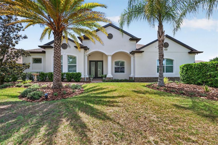 A RARE OPPORTUNITY FLOOR PLAN WITH OVER 3100 SQUARE FEET OF LIVING SPACE! Welcome to the sought-after Lakes of Mount Dora, where resort-style living meets timeless elegance in this stunning Medallion Homes Barbados model. Situated on a premium corner lot, this spacious 4-bedroom, 3,159 square foot residence also features a private office/den and an oversized bonus room, offering the perfect blend of comfort, flexibility, and luxury. Designed with both entertaining and everyday living in mind, the home showcases newly installed hardwood floors, tray ceilings, fresh interior and exterior paint, and beautiful plantation shutters throughout. The gourmet kitchen is a true centerpiece, complete with stainless steel appliances, a gas stove, Butler’s pantry, bar area, and abundant cabinetry for storage and style. The spacious primary suite is enhanced with custom California Closet-style built-ins, while thoughtful upgrades throughout the home include a newer roof, new tankless water heater, new dishwasher, new refrigerator, water filtration systems, ADT security system, and newly refreshed landscaping. Step outside to enjoy the covered and screened in back patio with partial water view featuring upgraded lighting and ceiling fans — the perfect place to relax year-round, enjoy BBQ, or a simple glass of wine after a long day. Living in Lakes of Mount Dora means enjoying one of Central Florida’s premier 55+ gated communities. Residents have access to exceptional resort-style amenities including an 18,000-square-foot clubhouse, resort pool and hot tub, tennis courts, pickleball courts, fitness center, arts and crafts room, game room, billiards room, library, social hall, scenic walking trails, and fenced gated RV and boat parking. The HOA also includes cable, internet, and reclaimed irrigation water for lawn care convenience. Just a few minutes to the charmful Historic Downtown Mount Dora, downtown Tavares, 1 hour to east coast beaches, and 45 minutes to downtown Orlando. This is more than just a home — it’s a lifestyle opportunity in one of Mount Dora’s most desirable active adult communities.
