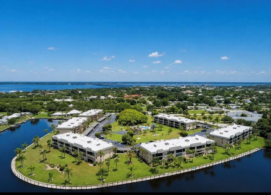 This stunning condo in the highly desirable waterfront community of Banyan Point —a true gem of sophisticated, turnkey living! Spanning over 1,398 square feet, the inviting open floor plan boasts neutral décor for a bright, airy feel. The modern kitchen shines with updated cabinetry, elegant countertops, and a generous breakfast bar ideal for casual meals or entertaining guests. The spacious living room floods with natural light and flows seamlessly through sliding glass doors to the expansive screened lanai—your perfect spot for relaxing or al fresco dining. The generous primary suite offers direct lanai access via slider, a large walk-in closet, and a private ensuite bath with dual sinks and a luxurious walk-in shower. A thoughtful split floor plan ensures privacy for guests, with a well-appointed second bedroom and full bath. Enjoy the lanai year-round thanks to versatile vinyl windows that keep out the elements while preserving stunning views. This prime unit has outstanding views of the Banyan Trees. Banyan Point's waterfront perks include assigned boat docks (up to 50 feet) —perfect for boating enthusiasts with quick, easy access to open water. Community amenities feature a beautiful year-round pool (heated in winter, chilled in summer for ultimate comfort). As part of Punta Gorda Isles, owners qualify for membership in the Punta Gorda Isles Civic Association (PGICA)—a vibrant social hub with over 40 special-interest clubs, fitness classes, educational seminars, entertainment events, and more (membership fee applies). Prime location puts you walking distance from the charm of downtown Punta Gorda, within easy walking or biking distance to the lively Fishermen's Village (shops, dining, and waterfront activities), scenic parks, walking trails, farmers markets, and more. This move-in-ready paradise won't last—don't miss your chance to own a slice of waterfront elegance in one of Punta Gorda's most sought-after communities. Schedule your private showing today!