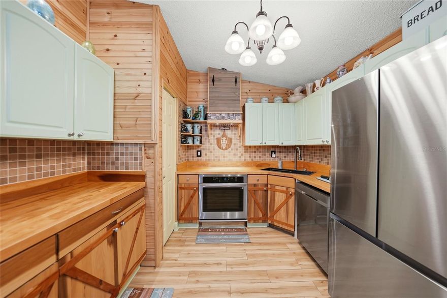RUSTIC CABIN RETREAT IN SUNNY SOUTHWEST FLORIDA. Welcome to 2213 NE 6th Place, where major recent upgrades meet the warmth and character. This beautifully reimagined 3-bedroom, 2-bath home with a 2-car garage offers exceptional peace of mind with a NEW ROOF (2023), NEW A/C (2023), NEW WATER HEATER (2024), INTERIOR REMODEL (2023), and HARDIE BOARD SIDING INSTALLED 06/28/2023—delivering durability, efficiency, and true move-in-ready confidence.

Beyond the upgrades, the home brings a rare and inviting charm seldom found in Cape Coral. Step inside and you’re greeted by rich textures, warm tones, and thoughtfully curated finishes that evoke the feeling of a peaceful mountain getaway. The living space is anchored by a striking electric fireplace, creating the perfect focal point for relaxing evenings and enhancing the home’s distinctive lodge-style ambiance.

The kitchen and living areas flow seamlessly together, ideal for everyday living or entertaining. Natural-inspired design elements and a comfortable, functional layout make the home feel welcoming and intimate. Both bathrooms are tastefully updated to complement the rustic yet refreshed aesthetic, while the bedrooms provide quiet, comfortable retreats.

A detached shed adds valuable extra storage for tools, hobbies, or outdoor equipment.

Situated on a quiet street in NE Cape Coral, this property offers convenient access to shopping, dining, schools, and major roadways—while still feeling like your own private escape.

If you’re looking for something truly different—where standout character meets major system updates—2213 NE 6th Place is a must-see. Ideal as a primary residence, seasonal getaway, or investment property with memorable charm and long-term value.