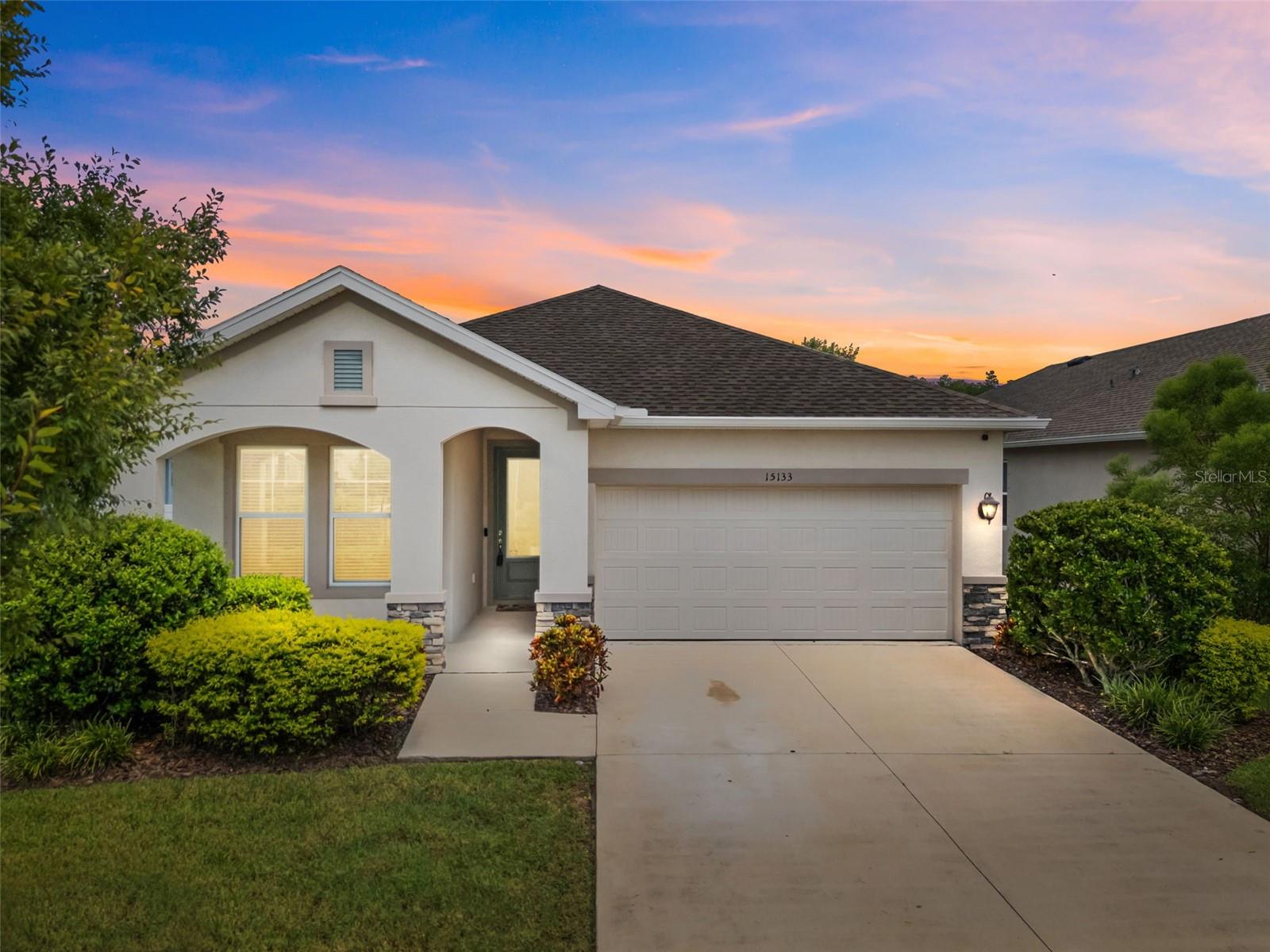 Smart layout, quality upgrades, and one of the best closet setups you’ll find—this David Weekley-built home in Asturia checks all the right boxes.
Built in 2020, this 3-bedroom, 2-bath home offers just the right balance of style and functionality. Step inside and you’ll notice tile flooring running through all the main living spaces, making cleanup easy and giving the home a clean, elevated feel from the start.
Just off the entry is the first of two secondary bedrooms, tucked beside a full bathroom with a tub/shower combo—making it a perfect guest retreat or home office setup. Continue down the main hallway and you’ll find the second bedroom just ahead, with the drop zone, garage entry, and laundry room located directly across the hall. One of the most impressive upgrades in the home? Both bedrooms feature custom built-in closet systems, adding sleek organization and maximizing storage—something that really makes a difference in a smaller floorplan like this.
The laundry room itself is outfitted with upper cabinetry and folding counter space—again, small touches that add real convenience to daily life.
Toward the back of the home, the layout opens into a light-filled living room, spacious dining area, and a crisp white kitchen with stainless steel appliances, gas range, upgraded backsplash, and granite-topped island. It’s a space that feels connected and easy to live in.
Slide open the back doors and you’ll step onto a covered and fully screened lanai—perfect for morning coffee or winding down at night. The backyard is fully fenced and offers plenty of room to play, entertain, or even add a future pool.
The primary suite sits quietly at the back corner of the home and brings in great natural light. The en suite bath includes dual vanities, a walk-in shower, and plenty of cabinet storage—but the true showstopper is the large walk-in closet with a custom built-in system and private access to the laundry room. It’s one of those features that makes everyday life just a little easier—and a lot more enjoyable.
Asturia is one of the most sought-after communities in Odessa, offering a resort-style pool, clubhouse, fitness center, playgrounds, dog park, and miles of walking trails. Zoned for top-rated schools and just minutes to the Veterans Expressway, this home combines comfort, convenience, and lifestyle in one neat package.
If you’ve been searching for something move-in ready with standout upgrades and a layout that works—this one’s worth a closer look.