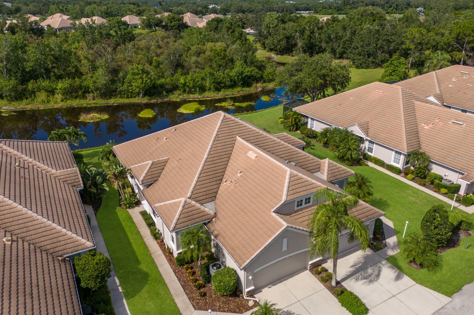 Welcome to 7032 Old Tabby Circle, a stunning updated villa nestled within the gates of the Lakewood Ranch Golf & Country Club. Enjoy tranquil water & preserve views in this sun-drenched, maintenance-free home that perfectly captures the essence of Florida living! Step inside to discover an open-concept layout ideal for both relaxed everyday living and effortless entertaining. The updated kitchen features white wood cabinetry, stainless appliances, quartz countertops and a breakfast bar...seamlessly connecting to the dining, flex room and the living room. The living room boasts large glass sliders that open to a screened lanai—the perfect place to enjoy a morning cup of coffee while taking in the beauty of the shimmering pond and endless native Florida bird sightings. This thoughtfully designed split-bedroom floorplan offers optimal privacy. The Primary suite overlooks serene water views & includes a custom designed walk-in closet, tray ceiling, plantation shutters & a beautifully updated en-suite bath with dual quartz vanities & a walk-in shower with new glass enclosure. The second bedroom & bath are ideal for guests, while the flex space offers versatility as a den, home office or an extra guest space.
Additional highlights not to be missed are: New luxury vinyl flooring, updated lighting & fans, tray ceilings & crown molding, plantation shutters, a freshly painted interior with a modern, transitional style, a NEW AC unit for peace of mind and a spacious two-car garage with ample storage. Located in the desirable Weston enclave, this home offers a low HOA fee that covers landscape & irrigation, driveway & sidewalk & roof cleaning annually, exterior painting as needed, cable tv & internet and access to the Weston community pool & spa, just steps away! Elevating everyday living into something truly special...The Weston neighborhood in particular offers an array of activities to include book clubs, Mahjong, Yoga & Water aerobics at the community pool! While a golf membership IS NOT included... There are OPTIONAL memberships available to join the Lakewood Ranch Golf & CC. These optional memberships for an ADDITIONAL FEE offer 4 championship golf courses, 18 Har-tru tennis courts, an Olympic size pool, pickleball, a state-of-the-art fitness center and 3 clubhouses with dining and social activities. This location can't be beat and is just minutes from the endless dining, shopping and entertainment experiences at LWR Main St, Waterside, CenterPoint and the UTC Mall area. It is also a short drive to Benderson Park, the new Mote Marine Aquarium, downtown Sarasota and our world-famous area beaches! Don't miss this opportunity to own your piece of paradise... schedule a tour today!