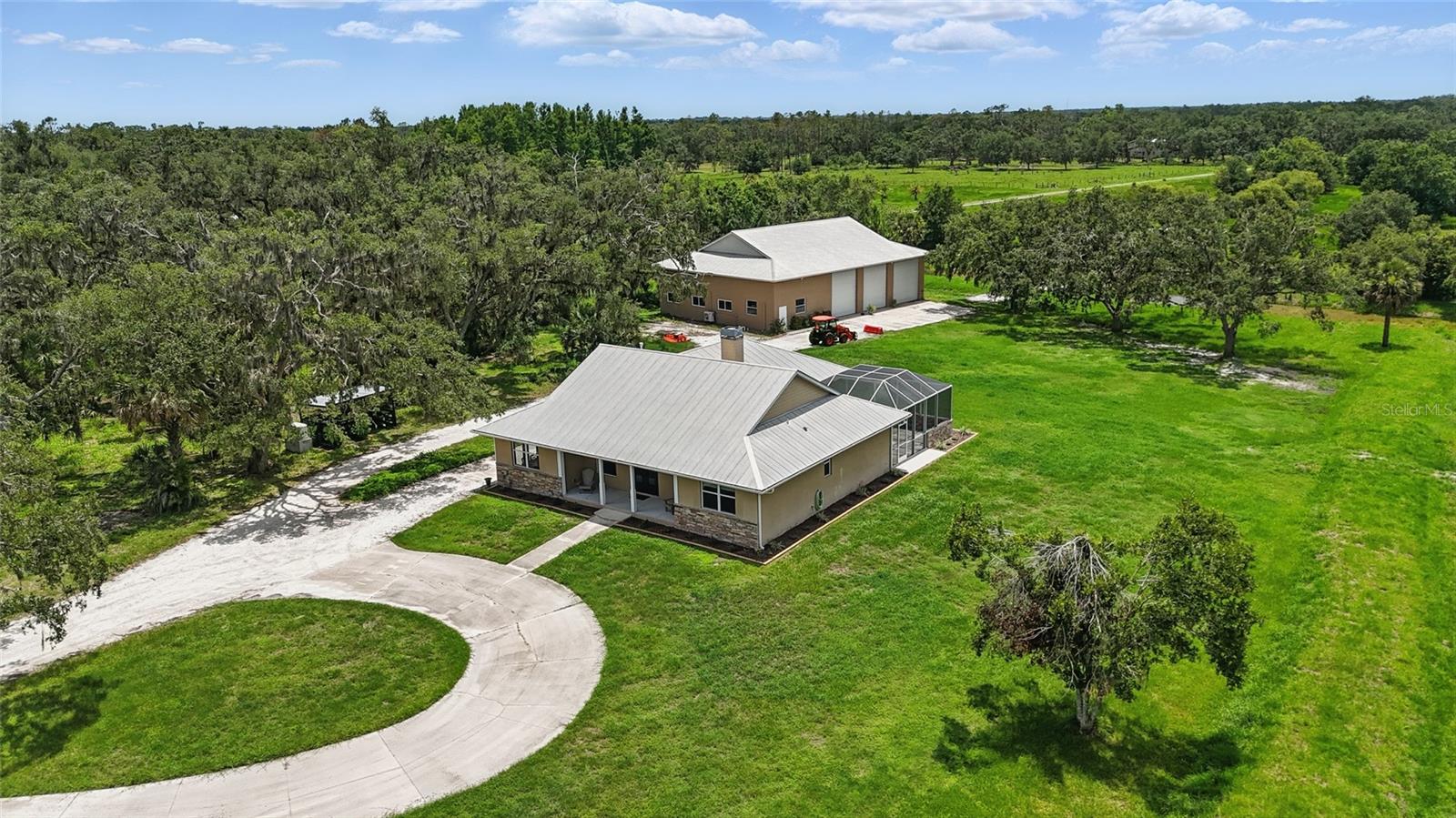 Enjoy the serenity of country living on 20 sprawling acres with all the modern high-end upgrades you could want. This tastefully renovated home is where modern comforts meet rustic charms. A warm, inviting, 3 bedroom 2 full bathrooms, open concept living home with custom finishes waits for you. The open great room is perfect for entertaining. The kitchen is a showcase of exceptional upgrades. Including custom kitchen cabinets raised to the ceiling; all stainless-steel appliances; 48” gas cooktop with electric oven, quartz countertops and backsplash; island seating for 12; Bosch dishwasher; voluminous kitchen storage; underlit cabinets; two 24” chillers; custom iron front doors; frameless glass shower and slipper tub in the master bathroom; gas tankless water heater; gas dryer; 4’ by 4’ porcelain tile throughout the house; custom closet system in all bedroom closets. LED ceiling lights with dimmer switches. Crown molding and tray ceiling in master bedroom. Whole house water system with additional drinking water filter. 2 power garage doors with keypad and garage door openers. Finished space in garage. Electric front gate with keypad and remotes. Whole house generator (including detached garage). 2 gas tanks totaling 750 gallons of propane gas. All televisions and wall mounts convey. Don’t miss your opportunity to own a turnkey country estate with every comfort accounted for — all just minutes from modern conveniences.