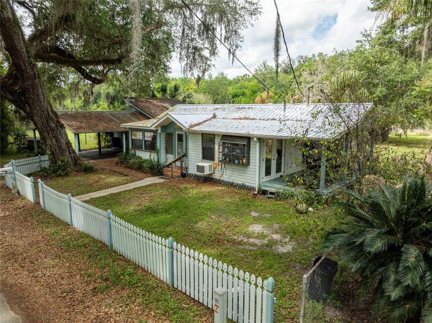 Tucked away in the heart of charming DeLeon Springs, just moments from the beloved Old Sugar Mill Pancake House and park, this adorable cottage offers the perfect blend of country living and cozy character. 

Situated on a spacious 0.34-acre lot, this quaint 2-bedroom, 1-bath home (built in 1948) is full of warmth and charm. With 736 square feet of thoughtfully used space, you’ll love the inviting feel created by cathedral ceilings, natural light, and a classic wood-burning stove that makes the living area feel like home the moment you walk in.

The kitchen and living spaces flow effortlessly out through French doors onto a sweet side deck, perfect for morning coffee or winding down in the evenings. The primary bedroom features beautiful natural light and a walk-in closet, while the bathroom includes tile finishes and a convenient tub/shower combo.

Outside, the property truly shines. A fenced yard with a charming picket fence adds to the storybook feel, while the large, private backyard gives you plenty of room to relax, garden, or entertain. Need space for hobbies, toys, or storage? You’ve got it! This property includes a substantial 38x23 block workshop on slab, plus an additional 24x23 metal-roof carport for everyday parking.

Recent updates, such as the new metal roof, offer peace of mind, while the enclosed front porch provides a cozy spot to enjoy the quiet surroundings year-round.

If you’ve been dreaming of a peaceful, cottage-style retreat with room to spread out yet still close to local favorites, natural springs, and small-town charm, this DeLeon Springs gem is ready to welcome you home.
Whether you're a hobbyist, outdoor enthusiast, or just someone craving a little more freedom and privacy, you’ll feel right at home here. Please note that all information and measurements are provided for accuracy, but are not guaranteed to be accurate. Buyers and their agents should verify all property details, including zoning, schools, HOA rules, pet policies, and other potential uses. Whether you're a hobbyist, outdoor enthusiast, or just someone craving a little more freedom and privacy, you’ll feel right at home here. Please note that all information and measurements are provided for accuracy, but are not guaranteed to be accurate. Buyers and their agents should verify all property details, including zoning, schools, HOA rules, pet policies, and other potential uses.