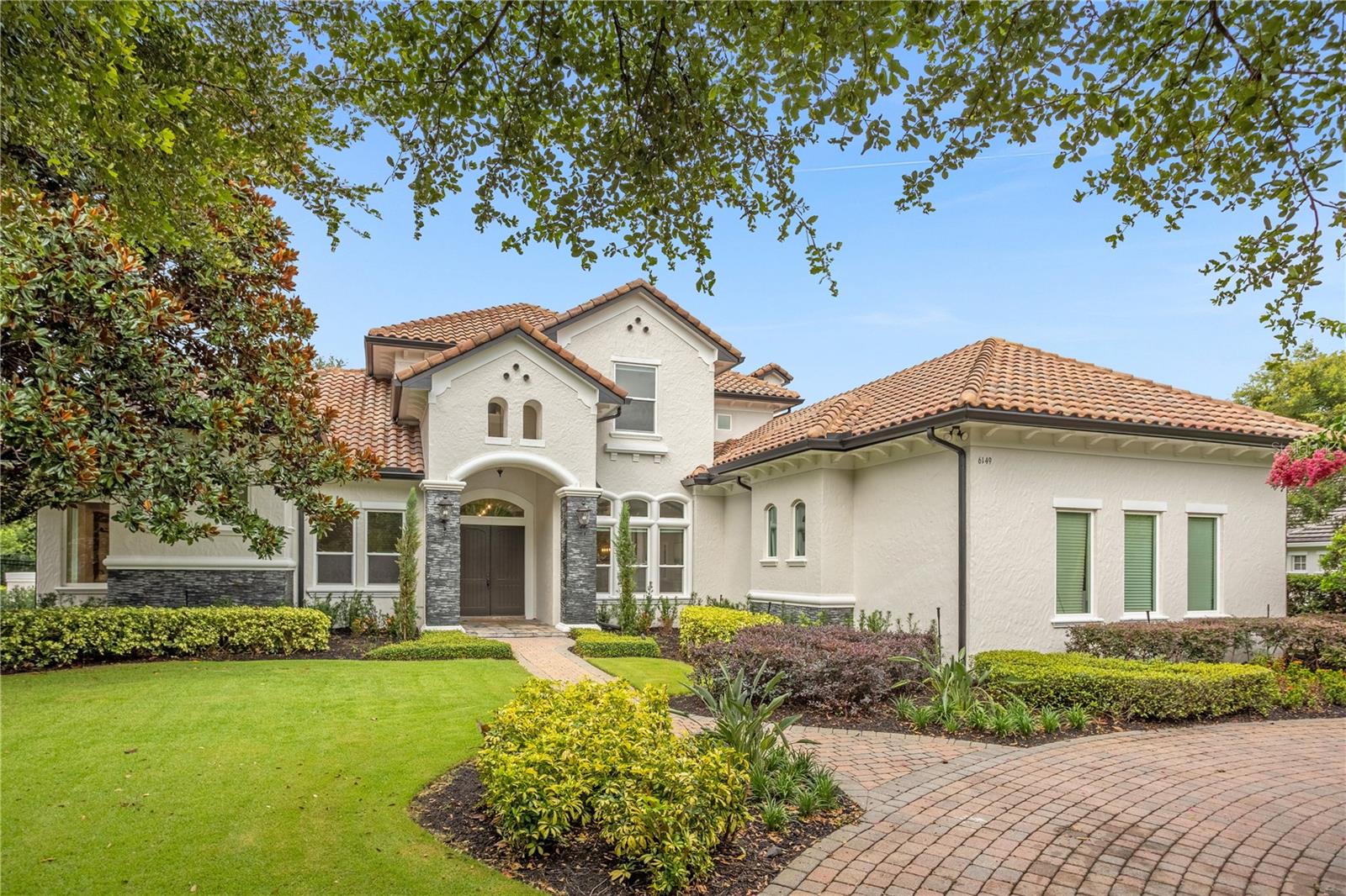 Under contract-accepting backup offers. Welcome to the epitome of luxury living! This recently renovated Spanish Mediterranean-style custom-built estate is nestled within the 24/7 guard-gated Reserve at Lake Butler Sound, a waterfront community. Prepare to be enchanted by the grandeur of this magnificent property, boasting 5 bedrooms and 5 bathrooms. As you step through the double front doors into the elegant entryway, your eyes are immediately drawn to the sparkling pool and waterfall, offering a picturesque view from the formal living room. The master suite is a haven of luxury, featuring an expansive bedroom with a stunning view, a fully renovated spa-like bathroom complete with a double shower and separate tub. The enormous walk-in closet is equipped with a granite-topped island, providing ample storage space. The gourmet kitchen is a chef's dream, showcasing soaring beamed ceilings, double ovens, a 4-burner gas stove with griddle, a walk-in pantry, an island with a prep sink and granite countertop, quartz countertop throughout the rest and custom-built cabinetry. The butler's pantry offers wine storage and a cooler, perfect for entertaining. Ample entertainment spaces including the family room boasts a gas fireplace, creating a cozy ambiance, while the billiard room and bar provides an ideal setting for socializing. Enjoy seamless indoor-outdoor living with an outdoor kitchen featuring a natural gas grill, an ice maker, a mini fridge, and a granite bar. The resort-style saltwater pool and spa beckon you to unwind and relax. With a beach entry, two gas fire bowls, and a separate gas fire pit, this outdoor haven is perfect for both tranquil moments and entertaining guests. Control the pool's lights and water features with a simple touch of a button. BRAND NEW POOL HEATER. This estate offers numerous additional amenities, including three NEWER AC units for optimal climate control, a separate lighted gazebo with a wood-burning outdoor fireplace, and a guest suite with full bathroom on the first floor. Home office downstairs as you enter the home. Upstairs, three more bedrooms and two full baths provide ample space for family and guests. One of these bedrooms has been converted into a movie theater giving you the feeling of going to the movies without leaving your home! BRAND NEW WINDOWS. Indulge in the finest luxury living with this exceptional estate. This home offers the perfect combination of elegance, comfort, and entertainment. Don't miss the opportunity to make this exquisite property your own and experience the true meaning of refined living. Schedule a showing today!