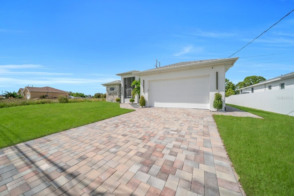 Photo of 1106 Floyd Avenue S, Lehigh Acres, FL 33976 (MLS # O6452829)