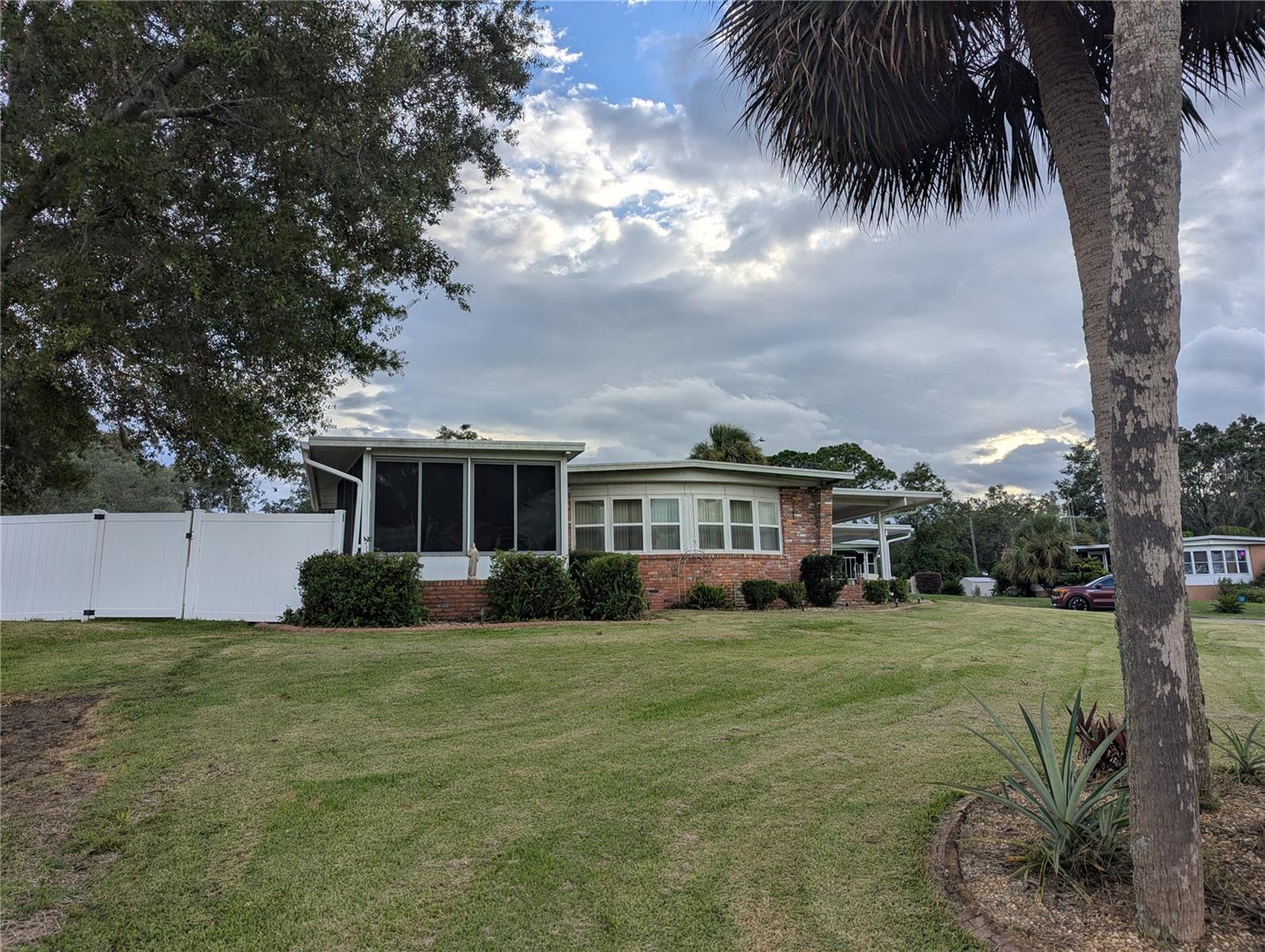 Welcome home to this 2 bedroom 2 bath manufactured home that sits on an oversized corner lot that overlooks a pond. Enjoy the freedom of NO HOA and NO LOT RENT- you own the land! The 23 x 12 Florida room is perfect for entertaining guests or for relaxing with your morning coffee enjoying the peaceful view of the pond. Just outside the Florida Room is an above ground pool with a deck. The pool area is enclosed with a vinyl privacy fence, offering privacy for your summertime pool parties. There is also a charming front porch area perfect for relaxing with a good book. Inside you will appreciate the spacious light filled living room that features large windows with views of the pond. The charming dining room is just off the kitchen which features a breakfast bar, allowing lots of space for family and friends to gather. The kitchen features newer appliances and lots of storage. There is a built in desk area with cabinetry that is currently being used as an office area. The hall bath features a shower and tons of cabinets. Spacious doesn't begin to describe the primary bedroom suite. Not only is this bedroom large, but it also offers a built in desk area, perfect for a makeup area, but it also has a ton of closet space. The primary bath has double sinks, a garden tub and a separate shower. The AC system has recently been upgraded to a heat pump system. All of the duct work was replaced along with the vapor barrier. Other recent improvements include gutters on the porch and FL room. This home offers a carport with ample parking, and an oversized garage with workshop area. Whether you are looking for a seasonal retreat or a year round residence, this well maintained home has it all with serene water views, updates, and no extra fees or restrictions. An added bonus is it's proximity to great fishing lakes. Don't miss out on this one!