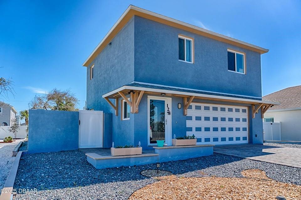 Charming Coastal Paradise with room for a pool, just steps from the ocean and no-drive beach. Walk to the county easement and easily access the river. Offering 1383 sq/ft of interior living space on two levels. The primary is spacious with a large walk-in closet & en-suite access to the master bath with large step in shower. A second bedroom, brand new kitchen and living space with vaulted ceiling round out the upper floor. Engineered hardwood flooring. Expansive views from every window on the second floor with a peek-a-boo view of the ocean. Downstairs is a guest bedroom with en-suite bath & an oversized laundry/utility room & PRIVATE ENTRANCE. The 554 sq/ft garage allows space for whatever your needs are. Extra storage space is located off the garage, under the stairs. Roof is in excellent shape. HVAC and W/H are from 2021, with lots of life left. New Stainless Stove, Microwave & Dishwasher in kitchen. 36'' upper cabs all with soft close and custom granite counters. Interior lighting fixtures have all been updated to a more modern theme. Hurricane windows are installed all around & the home is block all the way up. Facia and soffit are cement board to keep away the salt air. Attic is completely sealed with spray foam insulation and HVAC was recently retrofitted to maintain conditions in the controlled space. Private side patio with outdoor shower to clean off the beach before walking inside. The backyard is a blank canvas to become your personal oasis. It even has room for a pool! Original owner indicated home footers were built to specs to allow for a third story, if desired in the future. Original plans and home information will be turned over to buyer. Low maintenance landscape rounds out the outside of this property on a quiet one-way street. There is an easy access beach walk-over right at the end of the street, which is only about a 12 house walk away. This property embodies the coastal living lifestyle with ocean breezes nearly every day! Take a look today and start living your beach dreams.