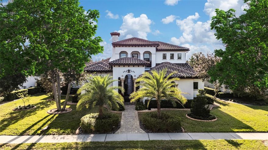 Custom Home in Prestigious Waterstone on Lake Butler.

This stunning Mizner/Palm Beach–inspired residence offers timeless elegance with stone columns and wrought-iron detailing that welcome you into a private front courtyard—your first outdoor living oasis.

Inside, the Grande Room impresses with a fireplace, intricate stone inlays, and a soaring 12-ft stained cypress ceiling. The newly remodeled eat-in gourmet kitchen is a chef’s dream, featuring an oversized island, granite and Calacatta quartz countertops, custom white cabinetry, a 42" KitchenAid refrigerator, and direct views of the home’s magnificent outdoor living spaces.

Perfect for entertaining, the residence is designed as a true private compound, enclosed by a 7-ft wall and showcasing a resort-style pool, spa, and expansive travertine decking. A double-size cabana, custom summer kitchen, and full-screen enclosure create a year-round outdoor oasis.

The home offers 5 bedrooms, 3.5 bathrooms, an office, bonus room, and butler’s pantry with wine chiller and ice maker. The luxurious primary suite features a spa-inspired bath with travertine and mosaic tiling, a rectangular soaking tub, and dual custom walk-in closets. French doors open directly to the oversized cabana for private access.

Additional highlights include:

Custom wood plantation shutters throughout

Energy-efficient features: tankless natural gas water heater, spray foam insulation, and Low-E glass doors & windows

Unique central network closet with CAT6, CAT5, and coaxial wiring

Upstairs poured-concrete subfloors for superior noise suppression

Waterstone residents enjoy private access to Windermere Prep and the unmatched lifestyle of Lake Butler.