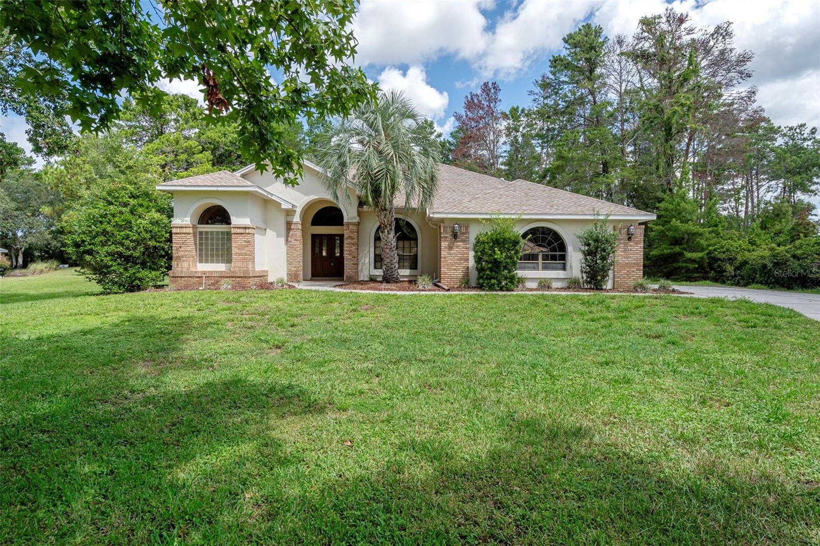 Located in the prestigious, deed-restricted community of Woodland Waters, this Christensen-built 3-bedroom, 3-bathroom estate offers luxury living on a spacious 1.3-acre (MOL) lot with a tranquil wooded backdrop. Step inside to discover a thoughtfully designed layout featuring a formal living room, formal dining room, and a spacious family room with a cozy gas-burning fireplace. The kitchen boasts solid oak wood cabinets, pull-out drawers on the lower cabinets, a breakfast bar, and dinette space, perfect for casual meals. Soaring 10-foot ceilings in all bedrooms enhance the open and airy feel throughout. The generously sized primary suite offers the ultimate retreat with a jetted soaking tub, separate walk-in shower, dual sinks, two walk-in closets, and sliding glass doors leading to the screened pool deck. Enjoy Florida living year-round in your private outdoor oasis featuring an in-ground pool recently refinished with Diamond Brite, a cabana-style outdoor kitchen, and a screened enclosure ideal for entertaining.
Additional highlights include: * Inside laundry room with sink * Oversized garage with space for a golf cart or workshop * Roof replaced in 2021 * Irrigation well with new pump (2022). Prime Location Near Nature’s Best:?Area attractions include Weeki Wachee Springs (just 3 miles south), Bayport on the Gulf (8 miles west), and Homosassa Springs (18 miles north), offering endless opportunities for boating, kayaking, manatee viewing, and exploring Florida’s natural beauty. Plus, you're just 50 minutes north of Tampa International Airport, making travel convenient and accessible. Don’t miss your chance to own this beautifully maintained, quality-built home in Woodland Waters — where privacy, nature, and upscale living come together.