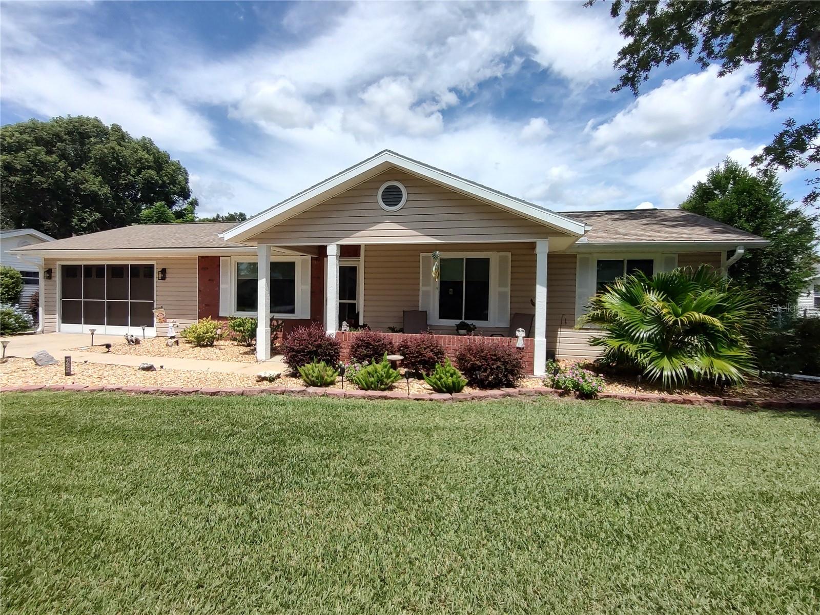 This is a REAL BEAUTY! A must see Hampton model with all the charm and brimming with upgrades. When you drive up the curb appeal beckens you to come inside. You are not dissapointed when you see the wonderful flooring through out, a modern kitchen and upgraded bathrooms. The kitchen features granite counters, stainless appliances and plantation shutters. The primary bedroom has a generous walkin closet for plenty of storage. The bathroom is totally updated and is light and bright. The guest bath has a custom vanity and granite counters.
The lcomfortable anai area is glass enclosed with custom window treatments. The exterior of the home is well cared for with lovely landscaping that shows the pure pride in ownership. The roof was replaced in 2024 and recently replaced AC. This one will not last long! SAY YES TO THIS ADDRESS!
