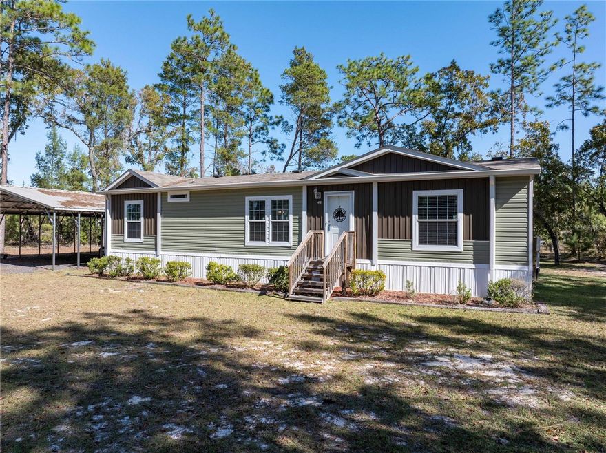 Hawthorne Haven is for sale!  Better than brand new 2023 Champion Home on 2 acres. This home features an electric fireplace and flat screen TV in the living room, primary suite with huge walk in closet, garden tub, separate shower, double sinks, chef's kitchen with island, Frigidaire appliances, laundry room with pantry, sheetrock interior walls and storage everywhere you look! Additions include 12 x 24 workshop with electric and shelving, 30 x 40 carport with millings drive, landscaping, circular driveway. 4'' well with submersible pump. Located at the end of Magnolia Road, this property backs up to a hunting preserve on the east side and a cattle ranch on the north. Quiet. Peaceful. Everything is new and well thought out. Working from home is no problem with high speed fiber internet available through Open Infra. Great location, country living close to small town shopping and convenient to Gainesville and Palatka. Come take a look today.