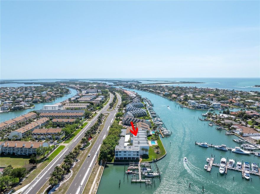 Endless potential and stunning water views await in the Yacht Haven community of Tierra Verde!
This spacious 2 bedroom, 2 full bathroom waterfront condo with a boat slip and lift offers a rare opportunity to create your ideal coastal retreat.  Step inside and you're greeted by the kitchen, which opens into the dining area accented by classic Saltillo tile flooring and a wood-accent wall that adds character and warmth.  Just beyond, the living area features vinyl plank flooring and large sliding glass doors that fills the space with natural light and lead to a private balcony overlooking the Tierra Verde Grand Canal.  Perfect for morning tea or enjoying the breathtaking sunsets.  The thoughtful split floor plan places the guest bedroom and full guest bathroom toward the front of the unit, offering comfort and privacy for visitors.  Tucked away at the back, the primary suite serves as a peaceful retreat with its own balcony access, a walk-in closet, and an updated en-suite bath.  A standout bonus is the approx 600 sq ft ground-floor, cabana-style flex space (non-heated), which includes an enclosed area with sliding glass doors leading to a screened lounge space and an open-air deck just steps from the pool.  Perfect for hobbies, storage, or simply unwinding by the water.
Yacht Haven is a boater’s dream, featuring a heated pool, lush mature landscaping, Port 32 Marina Tierra Verde right across the canal with a fueling station for quick access to the Gulf and just minutes from shopping, dining, and some of the best beaches the Gulf Coast has to offer.  Whether you're seeking a weekend escape, a renovation project, or full-time waterfront living, this is your chance to create something truly special.
Bring your vision; waterfront living starts here.