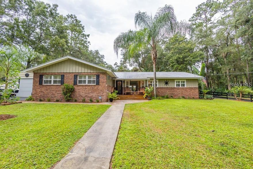 Welcome to one of Ocala's best-kept lifestyle gems,2.5 beautifully manicured acres paired with a home designed for families who love to gather, celebrate, and enjoy the outdoors. This 4-bedroom, 2.5-bath residence delivers comfort, space, and unforgettable entertaining areas both inside and out.  From the moment you step into the kitchen, you'll notice one of the home?s most remarkable features: a clear, unobstructed view straight through the living spaces and out across the stunning backyard. Sunlight pours in, the greenery becomes part of the home, and every day feels like you?re living in your own private park.  The heart of the property is the resort-style cabana, a massive, covered outdoor entertaining space overlooking the sparkling saltwater pool. With multiple seating zones, bar areas, ceiling fans, and a durable metal roof, this setup was built for birthday parties, family cookouts, football Sundays, or simply enjoying peaceful evenings outdoors. It?s the kind of backyard where everyone ends up? and nobody wants to leave.  Inside, the home offers warm finishes including crown molding, updated doors, granite counters, solid wood cabinetry, and an open feel ideal for family living. The oversized primary suite features dual closets and a beautifully updated bath. The additional bedrooms provide great flexibility for kids, guests, work-from-home setups, or multigenerational needs.

Outdoor lovers will appreciate the pristine grounds expansive, level, private, and beautifully maintained. Two outbuildings, including a finished 14x20 building with electric and A/C, offer incredible potential for a home office, teen hangout, hobby room, gym, or storage.

This property is perfect for buyers who want space, privacy, and a true Florida indoor/outdoor lifestyle, all while staying minutes from shopping, dining, schools, medical facilities, and everything Ocala offers. Homes with this kind of land, layout, and entertaining potential rarely come available don't miss the opportunity to make this one your family?s forever gathering place.