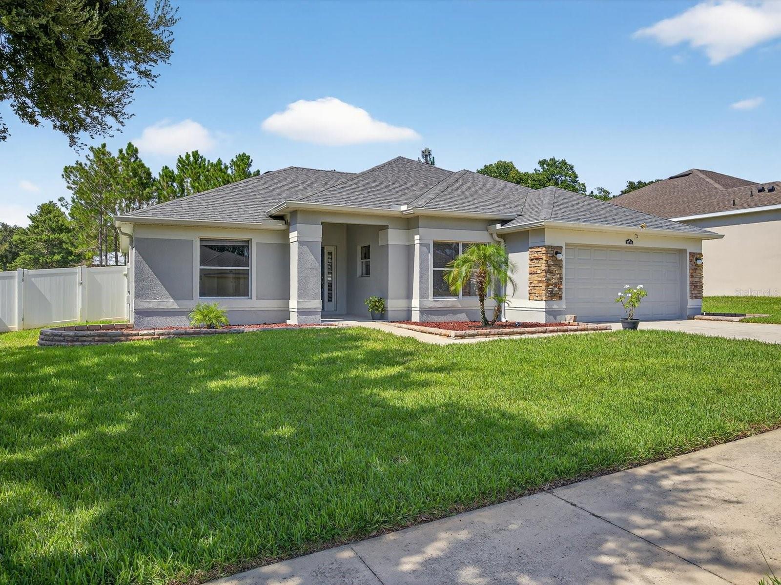 Welcome to this beautifully updated 3-bedroom, 2-bath ranch style block home with metal frame construction, located in the desirable community of The Reserve at Lost Lake. Perfectly positioned on an oversized lot near the community pool, this property offers over 2,000 square feet of well-designed living space, modern upgrades, and lasting value.
Enjoy peace of mind with a newer roof, new HVAC system, new hot water heater, and fresh interior and exterior paint. The remodeled kitchen features upgraded cabinetry, solid surface countertops, stainless steel appliances, and a cozy breakfast nook.
The primary suite includes a spacious walk-in closet and an en-suite bath with a soaking tub, separate shower, and dual vanities. The functional split floor plan offers two additional bedrooms and a full guest bath on the opposite side of the home for added privacy.
Step outside to a vinyl-fenced backyard and enjoy quiet Florida evenings on the covered patio. The rear neighbors are homesteaded on 30 acres adding additional rear privacy. The 2-car garage includes ceiling storage racks, pull down attic access and an attic space that has been reinforced for storage. The inside laundry room is spacious enough for a utility sink to be installed as well as a washer and dryer set, which are included.
Conveniently located within a short distance to top-rated Lake County schools, shopping, dining, medical services, and the Clermont Chain of Lakes, this home is ideal for those seeking comfort, style, and convenience. Located within 35 minutes of major theme parks, airports and easy access to area toll roads. The community is not gated but offers a well-maintained and tranquil environment.