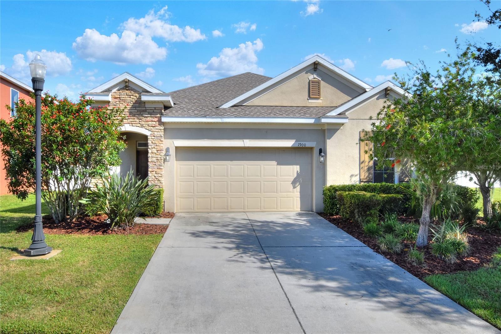 This executive style home is located in an established location close to Highway 60 and Highway 98 S for effortless commutes. Upon arrival, lush mature landscape welcomes you. Entering the residence, tile floors flow through the vast expanse of the great room, giving "open concept" a hat-tip. The kitchen features stainless appliances, a closet pantry, granite countertops, and a work station. Split floor plan provides separation for privacy, creating the ultimate home office environment, or quiet-time peaceful rest. All bedrooms are newly carpeted, reducing noise for each room. The indoor laundry is ideally located within the home so that distribution is facilitated with ease. The primary suite boasts a walk in closet, private water closet, soaking tub and plenty more room. Outdoors can be enjoyed from the covered lanai in the privacy of the secure fenced back yard, OR you can enjoy pleasant walks about the neighborhood on the paved sidewalks. Lawn maintenance included. Application can be made via TenantCloud.