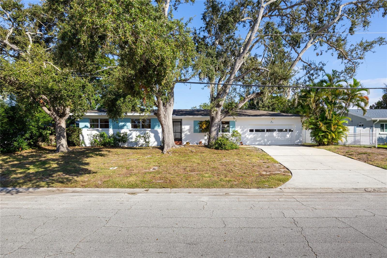Step back in time and fall in love with this vintage Dunedin charmer in Fairway Estates—one of the community’s most beloved neighborhoods. Built in 1957 and lovingly cared for by the same family since 1963, this home captures the warmth, character, and craftsmanship of a bygone era. If you’re tired of cookie-cutter remodels filled with gray flooring and all white cabinets in the kitchen & baths, this is your chance to own a true classic that offers timeless style and incredible potential.
Move right in and enjoy the home’s many well-maintained features, then update at your own pace to suit your taste and lifestyle. The freshly painted exterior and interior create a bright, welcoming feel, while large windows flood every room with natural light. Each of the three bedrooms is a corner room with windows on two sides, creating an airy sense of space. Gorgeous original wood flooring runs through much of the home—rich in character and in excellent condition.
Unlike most homes in Fairway Estates, this one was built with a raised crawl space foundation—an uncommon and desirable feature that provides easy access to plumbing and electrical systems, enhanced air circulation under the home, and a cooler, drier environment indoors during Florida’s humid months. It’s one of those subtle construction details that reflects thoughtful mid-century design and long-term practicality.
The spacious two-car garage includes a convenient half bath, ideal for rinsing off after a day at the beach or tending the garden. The large, pool-sized lot is fully fenced, offering privacy and room to expand. Practical updates include a roof installed in 2015, HVAC replaced in 2021, and a new water heater in 2024. The home features propane service for both the furnace and water heater and sits high and dry in a non-evacuation, Flood Zone X location for peace of mind year-round.
Fairway Estates residents enjoy access to Lake Saundra Park, a tranquil neighborhood retreat where neighbors gather to enjoy birdwatching, sunsets, and the occasional family of otters. The community is golf cart approved and ideally located near the recently restored Dunedin Golf Club—a historic Donald Ross design—as well as the Pinellas Trail, Dunedin Causeway, Honeymoon and Caladesi Island State Parks, and the Dunedin Community and Fine Arts Centers.
Come experience the nostalgia, character, and unbeatable location that make this home such a treasure—and imagine the possibilities for your own modern vision. Schedule your private showing today!