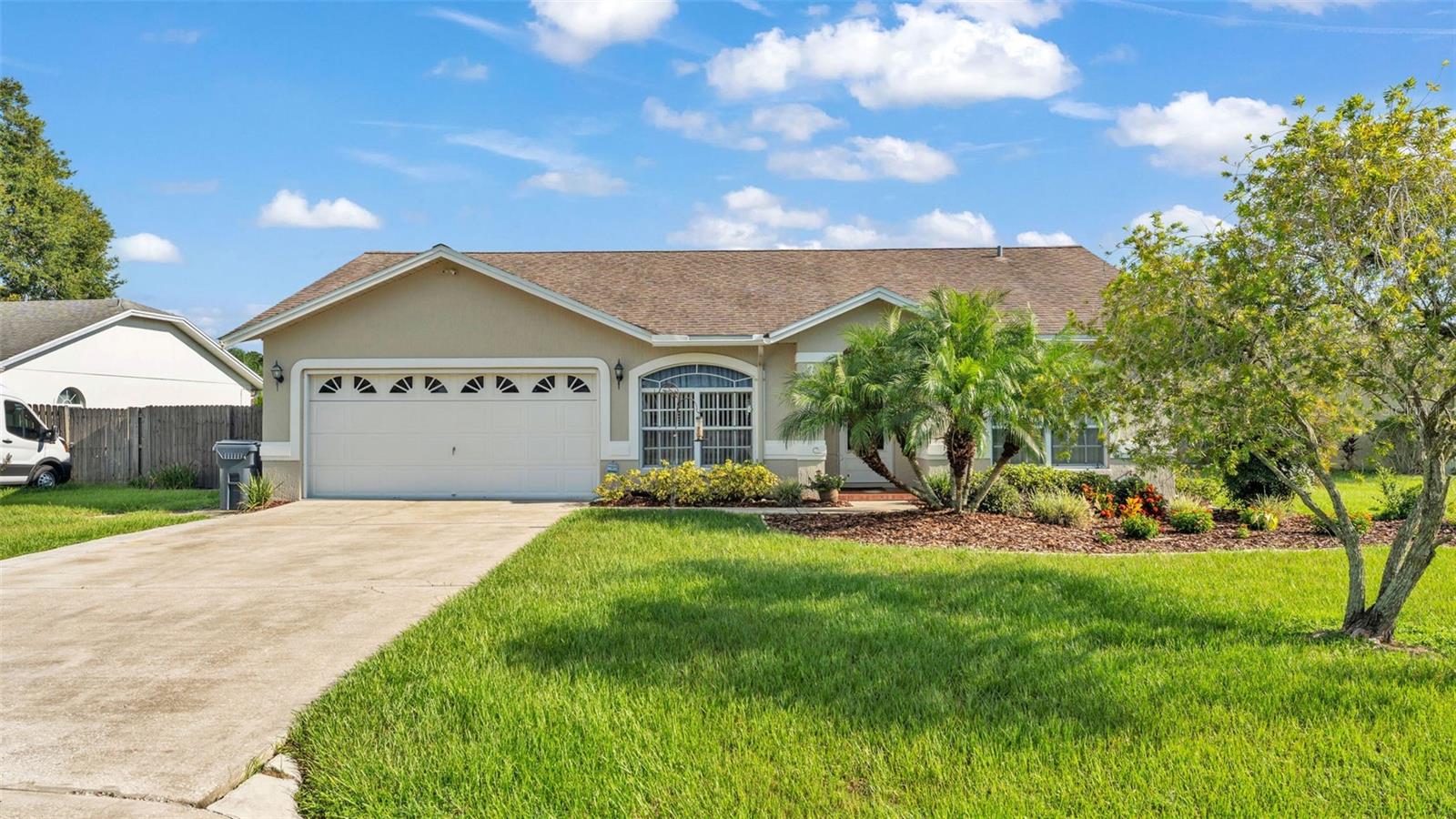 Welcome to 7908 Kaitlin Circle, a beautifully refreshed home in the sought-after Tangerine Trails community of North Lakeland. Built in 1995 and thoughtfully updated, this 3-bedroom, 2-bath residence offers 1,245 square feet of inviting living space, seamlessly blending modern upgrades with timeless charm. Step inside to soaring vaulted ceilings that enhance the open, airy feel of the main living area. The heart of the home is the fully remodeled kitchen, completed in 2023, boasting stone countertops, a custom-tiled backsplash, brand-new cabinetry, upgraded fixtures, and a layout designed for both style and functionality. Both bathrooms have been tastefully updated, including a luxurious 2025 remodel in the primary suite with fresh finishes and a spa-inspired atmosphere. Durable laminate flooring flows throughout the main living areas, while the bedrooms feature plush, updated carpet for added comfort. Every detail has been carefully considered, from the modern lighting to the refreshed paint, creating a warm, move-in-ready feel. Major systems have been diligently maintained, offering peace of mind for years to come: an AC system replaced in 2012 and serviced annually (most recently this year), a 2014 architectural shingle roof, a 2019 water heater, and a freshly painted exterior in 2022. The septic system has also been regularly serviced. Outside, enjoy one of the home’s standout features—a spacious, fully fenced backyard offering privacy, security, and plenty of room for outdoor living. Whether you envision summer barbecues, a play area, or a lush garden retreat, this backyard delivers. The two-car garage provides ample parking and storage space, adding convenience to everyday life. Ideally situated in a quiet, established neighborhood just minutes from shopping, dining, schools, and major commuter routes, 7908 Kaitlin Circle combines modern comfort with an unbeatable location. With stylish updates, generous outdoor space, and move-in-ready appeal, this home is ready to welcome its next owner. Schedule your private showing today to experience the best of North Lakeland living.