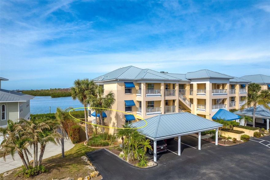 Boater’s Paradise on Lemon Bay – Corner Residence with Marina, Boat Lift & Spectacular Sunsets. Experience the ultimate boating lifestyle from this beautifully positioned first-floor corner condominium overlooking Lemon Bay and protected preserve, watch roseate spoonbills and pelicans roost across the water from your lanai. With an assigned boat slip and private boat lift included and marina costs covered in the condominium fees, you’ll enjoy effortless access to the Gulf for world-class fishing, island hopping, and waterfront dining. This 2-bedroom, 2-bath residence offers approximately 1,285 square feet of thoughtfully designed living space, enhanced by 2024 luxury vinyl plank flooring and impact glass windows for style and peace of mind. A full-length custom built-in wall unit in the living room provides both elegance and exceptional storage. As an end unit, this home enjoys additional privacy, abundant natural light, and valuable limited common elements not available to interior residences, including a 55 sq. ft. front lanai and a private entrance just steps from your assigned carport. The 105 sq. ft. enclosed lanai with western exposure showcases sweeping views of Lemon Bay and delivers breathtaking sunset skies year-round. Recent improvements provide confidence and value, including a new HVAC system (2022). The community has undergone extensive enhancements in 2025 with fresh exterior paint and new landscaping. The beautifully renovated pool area now features a spa, expansive deck, shade structure, and lush tropical surroundings, all heated by an energy-efficient geo-thermal system. Additional community upgrades include metal roofs, elevators, carports, amd resurfaced parking areas. Launch your boat for a quick cruise to Stump Pass or Boca Grande, fish for snook and tarpon at sunrise, or simply relax as manatee and dolphins glide across Lemon Bay. This is Southwest Florida waterfront living at its finest. Don’t miss this rare opportunity to own a truly move-in-ready marina-front residence — schedule your private showing today.
