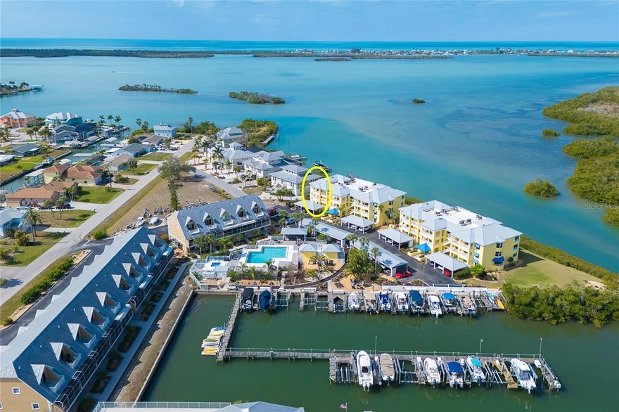 Boater’s Paradise on Lemon Bay – Corner Residence with Marina, Boat Lift & Spectacular Sunsets. Experience the ultimate boating lifestyle from this beautifully positioned first-floor corner condominium overlooking Lemon Bay and protected preserve, watch roseate spoonbills and pelicans roost across the water from your lanai. With an assigned boat slip and private boat lift included and marina costs covered in the condominium fees, you’ll enjoy effortless access to the Gulf for world-class fishing, island hopping, and waterfront dining. This 2-bedroom, 2-bath residence offers approximately 1,285 square feet of thoughtfully designed living space, enhanced by 2024 luxury vinyl plank flooring and impact glass windows for style and peace of mind. A full-length custom built-in wall unit in the living room provides both elegance and exceptional storage. As an end unit, this home enjoys additional privacy, abundant natural light, and valuable limited common elements not available to interior residences, including a 55 sq. ft. front lanai and a private entrance just steps from your assigned carport. The 105 sq. ft. enclosed lanai with western exposure showcases sweeping views of Lemon Bay and delivers breathtaking sunset skies year-round. Recent improvements provide confidence and value, including a new HVAC system (2022). The community has undergone extensive enhancements in 2025 with fresh exterior paint and new landscaping. The beautifully renovated pool area now features a spa, expansive deck, shade structure, and lush tropical surroundings, all heated by an energy-efficient geo-thermal system. Additional community upgrades include metal roofs, elevators, carports, amd resurfaced parking areas. Launch your boat for a quick cruise to Stump Pass or Boca Grande, fish for snook and tarpon at sunrise, or simply relax as manatee and dolphins glide across Lemon Bay. This is Southwest Florida waterfront living at its finest. Don’t miss this rare opportunity to own a truly move-in-ready marina-front residence — schedule your private showing today.