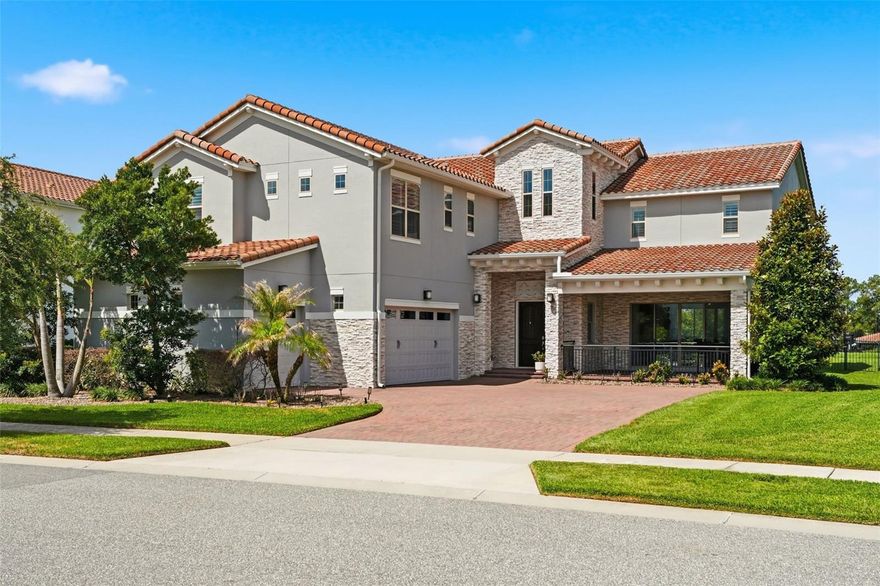 LAKEFRONT LUXURY LIVING NEAR ORLANDO’S WORLD-FAMOUS ATTRACTIONS! Welcome to 9110 Morgana Court, an extraordinary 5-bedroom, 5-bath waterfront estate offering the perfect blend of luxury, privacy, recreation, & resort-style outdoor living. Nestled on a gorgeous skiable lake in Orlando, this exceptional home sits on an oversized homesite with private dock access, breathtaking sunset views, & endless opportunities to enjoy the Florida lifestyle.  From the moment you arrive, you will appreciate the impressive curb appeal, expansive yard, & thoughtful upgrades throughout. Step into your own private outdoor paradise featuring an oversized heated saltwater pool, relaxing 8-person spa, poolside fire feature, & an incredible Paradise Grill outdoor kitchen designed for entertaining. The massive covered lanai with retractable screens creates seamless indoor-outdoor living while offering shaded seating space for hosting family & friends year-round. Upstairs, an additional rear balcony overlooks the peaceful lake and provides the perfect retreat to enjoy your morning coffee, unwind in solitude, or simply take in the beauty of nature surrounding you.  Follow the walkway to the covered private dock where you can enjoy boating, fishing, paddleboarding, or relaxing evenings watching stunning lakefront sunsets from the shaded seating area. The fully fenced backyard offers exceptional privacy while embracing expansive water views and the tranquility of true waterfront living.  Inside, this home showcases a highly flexible floor plan designed for multigenerational living, work-from-home needs, entertaining spaces, or guest accommodations. The downstairs mother-in-law suite features its own private bath and walk-in closet, while the spacious downstairs bonus room overlooking the lake creates the perfect flex space for a media room, office, gym, or lounge area. Upstairs, a huge loft opens toward the rear balcony and captures beautiful lake views while providing additional living space.  The heart of the home is the expansive gourmet kitchen featuring an oversized center island, premium Wolf gas range, built-in wall oven and microwave combination, gorgeous fixtures, abundant cabinetry, and open-concept flow ideal for entertaining. Natural light fills the home throughout, highlighting the upgraded lighting, custom finishes, and elegant details around every corner. Surround sound inside and outside enhances the luxury experience and creates the perfect atmosphere for entertaining.  The luxurious primary suite is perfectly positioned upstairs overlooking the lake and offers serene water views, a spa-inspired bath with an oversized walk-in shower, and an exceptionally large walk-in closet. The additional bedrooms are split planned for privacy, oversized, and filled with natural light.  Extensive upgrades include new exterior paint completed in 2026, custom window treatments, upgraded stair rails, upgraded lighting fixtures, retractable patio screens, a fully upgraded outdoor kitchen, surround sound inside and out, heated saltwater pool and spa, oversized fenced homesite, covered dock access, and countless additional enhancements that make this property truly move-in ready.  Conveniently located near Orlando’s premier attractions, shopping, dining, entertainment, and major highways, this rare lakefront opportunity combines luxury living with everyday convenience. Homes like this rarely become available. Schedule your private showing today.
