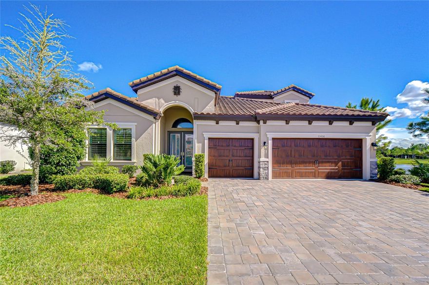 Welcome to this gorgeous Starkey Ranch home. It is luxurious, comfortable and every detail feels intentional. Discover the perfect blend of elegance, comfort, and modern design in this exquisite Homes by WestBay Bayshore II floor plan. A true showstopper where every detail has been thoughtfully created. Nestled on a beautiful conservation lot, this executive-style home offers 5 bedrooms, 4 bathrooms, a sunroom, and a spacious second-floor flex area ideal for guests, in-laws, or a private office retreat.
Step through the grand foyer with tall ceilings, wood accents, and crown molding, and you’ll instantly feel the sophistication that flows throughout the home. The open-concept grand room, dining area, and chef’s kitchen form the heart of this home — perfect for family gatherings and entertaining. The gourmet kitchen features: GE Café Series appliances, including a six-burner gas cooktop, Advantium oven, and refrigerator with a built-in Keurig coffee maker. A gorgeous, tiled backsplash ties the entire space together.  An extended granite island with table-height seating and abundant cabinetry providing ample entertaining and storage in this amazing space.
The grand room showcases decorative beams, a stone accent wall, designer lighting, and luxury vinyl plank flooring that flows seamlessly throughout the main level and staircase. The spacious master suite is both stylish and serene, featuring a shiplap accent wall, two large walk-in closets with custom closet systems, and a luxurious spa-style bath complete with a rainfall shower, handheld sprayer, dual granite vanities, and shiplap detailing. Downstairs includes three additional bedrooms and two full bathrooms, while upstairs offers a private bedroom, full bath, and expansive bonus room — perfect for multigenerational living, a teen suite, or a dedicated workspace.
Throughout the home, Hunter Douglas large louver plantation shutters provide timeless elegance, privacy, and energy efficiency.
Step outside to your private backyard retreat overlooking peaceful conservation views. Relax in the heated saltwater pool with spillover spa, or entertain with the fully equipped outdoor kitchen featuring a grill with vent hood, refrigerator, icemaker, storage, and granite countertops. Whether you’re hosting a summer barbecue or enjoying a quiet evening, this space delivers resort-style living every day. 
Located in one of Tampa Bay’s premier master-planned communities, you’ll enjoy top-rated schools, parks, trails, pools, playgrounds, and local restaurants and shopping— all accessible by golf cart! Plus, Publix and Starkey K-8 are just minutes away. Move-in ready and meticulously maintained, this home truly has it all. Bring your furniture — and start living the Starkey Ranch lifestyle today!