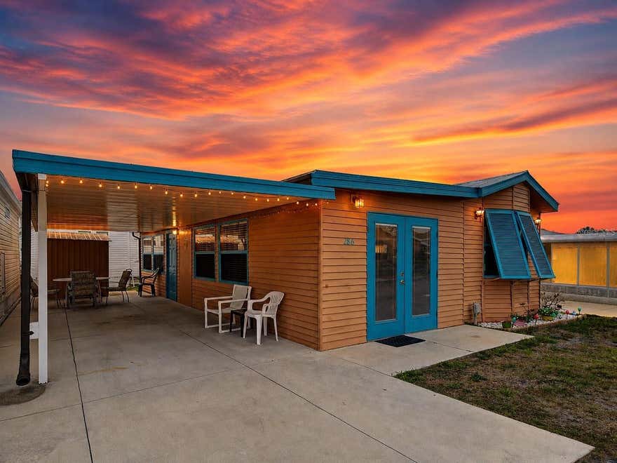 Welcome to Holiday Travel Park where coastal comfort meets every-day convenience in Englewood! THIS IS THE LARGEST UNIT CURRENTLY AVAILABLE. Enjoy a very well maintained property with a charming theme and newly built carport and new metal roof. Featuring 2 bedrooms and a lot more space than any other unit in the community has to offer, this is the obvious choice! If you're looking for the perfect 55+ community, then there is no need to keep looking. For a super low fee of $140 a month, you get access to a maintenance free lifestyle and a gated community with tons of amenities such as a beautiful pool, community boat ramp, bocce ball, shuffleboard, horseshoes, laundry facilities, activity center, yard maintenance, indoor pickle-ball courts, pool tables, dog parks and tons of weekly social activities. Water, sewer and trash are also included in the $140 monthly fee. This is truly the best bang for your buck. Enjoy optional boat/RV storage if you'd like to store them on-site for a small fee. The community is located within 10 minutes of Englewood and Manasota Key Beach, golf courses, shopping, dining, marina's, medial office, hospital and more. Right up the road from Historic Dearborn Street, Farmers markets and multiple marinas. This property puts you close to everything while still offering a peaceful residential setting. Don't miss this property - Schedule your showing today!