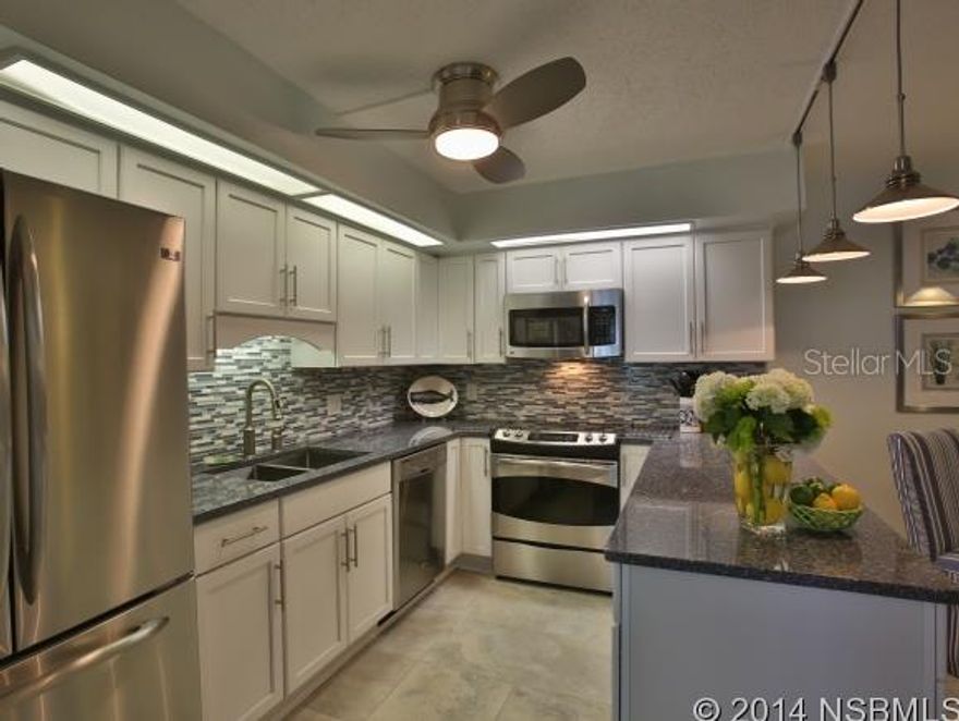 RARE BEACHSIDE FIND in a well established small community where available units in original condition sell quickly and are in demand!  This 2BR 2.5 BR beach house with one of the few larger avail hardscape very private patio nestled in a vibrant part of the hardwood canopy," right across the street to the stunning no drive beach"This unit has been beautifully renovated from top to bottom with gorgeous top of the line materials and fittings and is a MUST SEE.  18" x 18" travertine flooring throughout the main floor and all bathrooms, quality Shaw carpet upstairs.  Large patio second floor is accessible from both good size bedrooms. Beach white cabinet kitchen with polished natural stone countertops and pencil glass and carerra marble tile backsplash and deep dual sink. Nice dining space. Four excellent SS appliances with extended warranty. New central aircon unit winter 2013, new dryer Dec 2013, upgraded electrical and so much more.Lovely new aluminum sunroom off the kitchen and living area . Four new double top of the line PGT Winguard impact resistant UV filtering patio sliders which qualify for insurance premium reduction.  All bathrooms have a real "wow" factor and feature beautiful custom all hardwood free standing white vanities with luxury sinks and quartz vanity tops , designer tile finishings, lighting, mirrors and bath fixtures. Soaker size tub and rain head shower in the 2nd bathroom beautiful rain head and wand walk in shower in the master ensuite, dual sinks. Perfect soft beach colors throughout for that truly classy beach house feel. Pool, tennis and shuffleboard very good fees for the beachside.Don't miss this one. This is not a paint only " upgraded" unit. It's quality renovated priced well for the many features ,beautiful and move in ready. Beach house away from home or luxury rental? Perfect either way! ;Water: City