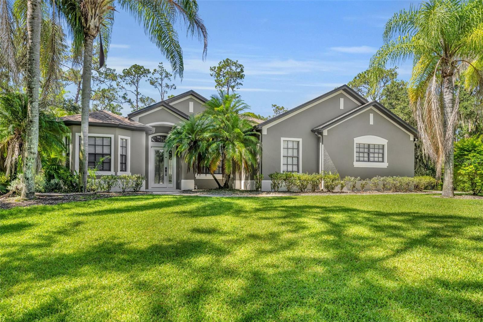 Rare Find in Live Oak Estates!
This stunning executive home is tucked away on a 1.07-acre cul-de-sac lot, surrounded by lush landscaping and majestic trees that create an incredibly private and peaceful setting. The backyard borders a wooded conservation area, where you’ll often spot deer, owls, hawks, wild turkeys, and sandhill cranes right from your porch.
Inside, the home offers 4 spacious bedrooms, 4 full baths, and a dedicated office with its own private entrance—perfect for working from home or running a business. The oversized three-car garage provides plenty of room for vehicles, a home gym, or a workshop.
The open floor plan is filled with natural light thanks to 10-foot ceilings and expansive rear-facing glass sliders that seamlessly connect the indoors with the outdoors. Just past the cozy living room with fireplace, you’ll find direct access to the screened lanai, luxurious master retreat, and the gourmet kitchen, breakfast nook, and family room—all featuring pocketing sliding doors that open to the resort-style pool area.
The screened pool and lanai are an entertainer’s dream, complete with a swim-up bar, spacious deck, and even an outdoor hot/cold shower. The chef’s kitchen includes stone countertops, 42” wood cabinetry, built-in oven and microwave, cooktop vented to the exterior, island with prep sink and second disposal, a breakfast bar, wine fridge, and a roomy closet pantry.
Recent improves included: Roof replaced 2020, A/C 2024, Pool pump 2023, Salt cell 2025 and new water treatment system and slab poured 2021
This home is move-in ready and ideally located with quick access to the 417, 528, and Orlando International Airport, plus just minutes from Lake Nona’s Medical City and its top-rated schools. You’re also only 25 minutes from Downtown Orlando and 35 minutes to beaches and Disney attractions.
If privacy, nature, and luxury living are what you’re looking for—this home checks every box.