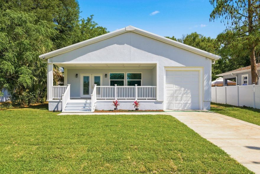 Experience modern luxury and coastal elegance in this brand-new, steel-frame construction masterpiece. This stunning three-bedroom, two-bathroom home combines structural integrity with high-end designer finishes, offering a low-maintenance lifestyle perfectly situated for a quick commute to MacDill AFB and Downtown Tampa. The interior is defined by a wide-open floor plan with soaring vaulted ceilings accented by a rustic wood beam, creating an airy and sophisticated atmosphere. Durable flooring flows seamlessly throughout the entire home with absolutely no carpet to be found. The kitchen serves as a gourmet centerpiece, featuring a spacious layout with all-new cabinetry, sleek quartz countertops, and a full suite of new stainless steel appliances. While the living area is impressive, the bathrooms are the undisputed star of the show, both featuring exquisite floor-to-ceiling porcelain tile and designer gold-tone fixtures plus back lit, fog-less mirrors. The primary suite is a true retreat, boasting a large walk-in closet and an ensuite bathroom with a massive walk-in shower equipped with a luxury rain shower head. The guest bathroom is equally impressive, featuring a deep-soaking freestanding tub with shower wand, that adds a spa-like feel for family or visitors. Practicality meets comfort with the inclusion of an energy-efficient tankless water heater and a brand-new septic system. The exterior living spaces are just as inviting, highlighted by a large covered front porch and a fully fenced-in backyard. This home is a rare blend of modern industrial strength and sophisticated interior design, offering a turnkey opportunity in a prime location.