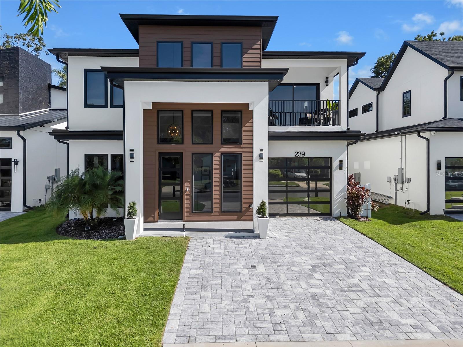In Orlando’s vibrant SoDo district, this contemporary Four-Bedroom, Three-Full, and Two-Half-Bath residence delivers bold design, refined finishes, and unforgettable living — with $100,000 in upgrades and the rare offering of a fully furnished 1BR/1BA Apartment with private entrance, currently operating as a high-performing Airbnb but ready to flex for your lifestyle, whether as a Multi-Generational Space or an Extraordinary Guest Suite.
The Foyer establishes the design language for the home, with its soaring 24-foot ceiling, statement lighting, and artfully placed windows that infuse the interiors with light and volume. The flow continues effortlessly into a Lounge and Music Studio, Formal Dining, and a Living Room anchored by a modern all-seasons fireplace, custom shelving, granite Wet Bar, and integrated sound system — designed to be experienced, yet adaptable to your lifestyle and desires.
At the home’s center, the Gourmet Kitchen is the heart of the home — where culinary creativity, living, and gathering converge. A 10-foot Waterfall Quartz Island with seating for five blends artistry and function, complete with a Bosch Dishwasher, integrated recycling and storage, and a bronzed designer sink. Dual Bosch Refrigerator–Freezers and a Built-In Bosch Convection Oven and Microwave combination are paired with designer soft-close cabinetry, while the Induction Cooktop with Pot Filler is crowned by a sculptural vent hood — a focal point of both performance and design. A generous Walk-In Pantry keeps you organized, while a dedicated Coffee Bar overlooks the Pool, turning daily ritual into an experience framed by resort-style views.
Upstairs, a Loft flexes as your creative space, leading to an extraordinary Owner’s Suite with Private Office, Chandelier-Lit Dressing Room, and Spa-Inspired Bath featuring a floor-to-ceiling tiled shower with five heads, backlit mirrors, and pendant lighting. Two oversized Bedrooms share a full Bath with elegant stone finishes, while an expansive upstairs Laundry Room adds convenience.
The design language established inside extends seamlessly into your backyard oasis, creating an Outdoor Living environment as intentional as the interiors. A terrazzo-tiled Lanai, sparkling Pool, Florida Outdoor Kitchen, and Shower complete the experience — spaces crafted for both relaxation and year-round enjoyment.
Every detail reinforces the same message: this is a home of statement and style.
More than a residence, this is a reflection of you — bold, modern, unforgettable. And while its design language is striking, it remains open to your vision, your lifestyle, and your priorities, expanding to become the backdrop for the life you choose to create.Please
consult your REALTOR® for a private tour and complete list of upgrades.