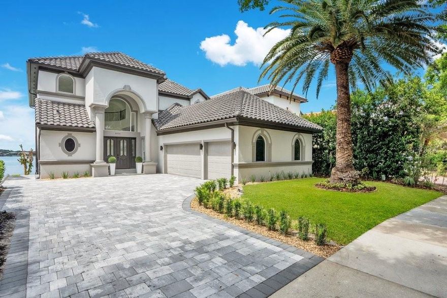 Welcome to 8010 Firenze Blvd, an extraordinary Lakefront estate in the beautiful, 24-hour guard-gated community of Vizcaya, completely transformed by a $700,000 remodel and never lived in since. Set on the shimmering shores of Big Sand Lake, this contemporary showpiece offers nearly 6,300 square feet of refined living with 5 bedrooms, 5.5 baths, and a private elevator for effortless access across multiple levels. Every detail has been curated for modern luxury, from sleek contemporary finishes to porcelain tile flooring throughout. The chef’s kitchen is beautifully upgraded with stainless steel appliances, a statement hood, and designer pendant lighting, perfectly positioned for both everyday living and elevated entertaining. Designed for privacy and flexibility, the home features two lavish primary suites on separate floors, along with built-in closets and exceptional storage throughout. Escape into your dedicated movie room with ambient lighting and sound dampening or enjoy the lower level game room and gym with seamless access to the backyard retreat. Step outside to your private resort to a large pool with spa, illuminated step lighting across the deck, and breathtaking panoramic views of Big Sand Lake. With the potential to add a boat dock, the lifestyle here is truly unmatched. Big Sand Lake spans over 1,000 acres of pristine, spring-fed water ideal for boating, watersports, fishing, and skiing. Beyond the home, Vizcaya offers a clubhouse, fitness center, and tennis courts, all just moments from the famed Restaurant Row, upscale shopping, and Orlando’s world-class attractions. Plus, you are only about 20 minutes from the international airport, an unbeatable location. A rare opportunity to own a fully remodeled, never-lived-in after the renovation, lakefront masterpiece in one of Central Florida’s most coveted enclaves. Make this luxurious estate yours today. Be sure to click on the virtual tours.