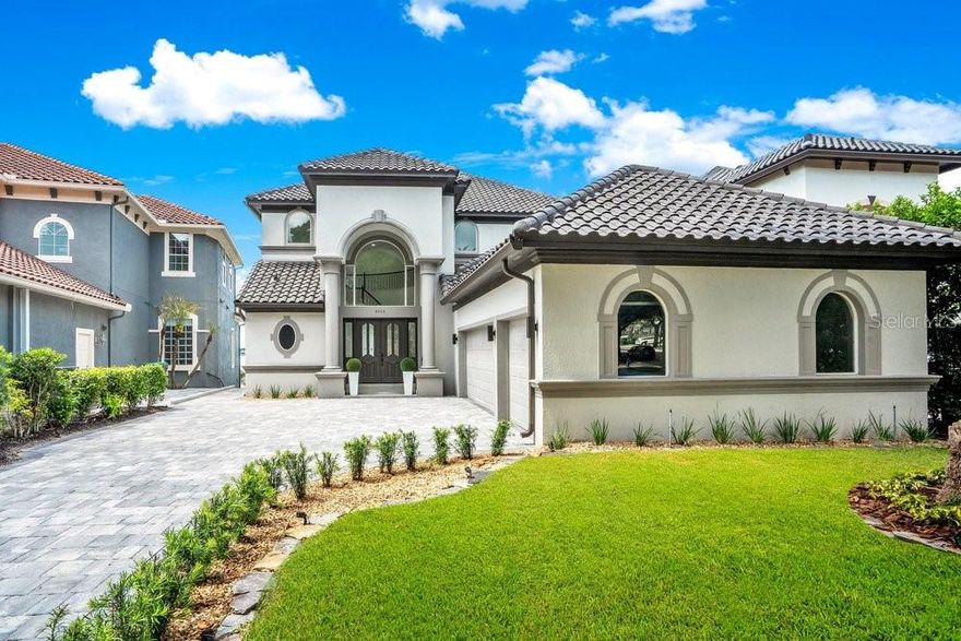 Welcome to 8010 Firenze Blvd, an extraordinary Lakefront estate in the beautiful, 24-hour guard-gated community of Vizcaya, completely transformed by a $700,000 remodel and never lived in since. Set on the shimmering shores of Big Sand Lake, this contemporary showpiece offers nearly 6,300 square feet of refined living with 5 bedrooms, 5.5 baths, and a private elevator for effortless access across multiple levels. Every detail has been curated for modern luxury, from sleek contemporary finishes to porcelain tile flooring throughout. The chef’s kitchen is beautifully upgraded with stainless steel appliances, a statement hood, and designer pendant lighting, perfectly positioned for both everyday living and elevated entertaining. Designed for privacy and flexibility, the home features two lavish primary suites on separate floors, along with built-in closets and exceptional storage throughout. Escape into your dedicated movie room with ambient lighting and sound dampening or enjoy the lower level game room and gym with seamless access to the backyard retreat. Step outside to your private resort to a large pool with spa, illuminated step lighting across the deck, and breathtaking panoramic views of Big Sand Lake. With the potential to add a boat dock, the lifestyle here is truly unmatched. Big Sand Lake spans over 1,000 acres of pristine, spring-fed water ideal for boating, watersports, fishing, and skiing. Beyond the home, Vizcaya offers a clubhouse, fitness center, and tennis courts, all just moments from the famed Restaurant Row, upscale shopping, and Orlando’s world-class attractions. Plus, you are only about 20 minutes from the international airport, an unbeatable location. A rare opportunity to own a fully remodeled, never-lived-in after the renovation, lakefront masterpiece in one of Central Florida’s most coveted enclaves. Make this luxurious estate yours today. Be sure to click on the virtual tours.