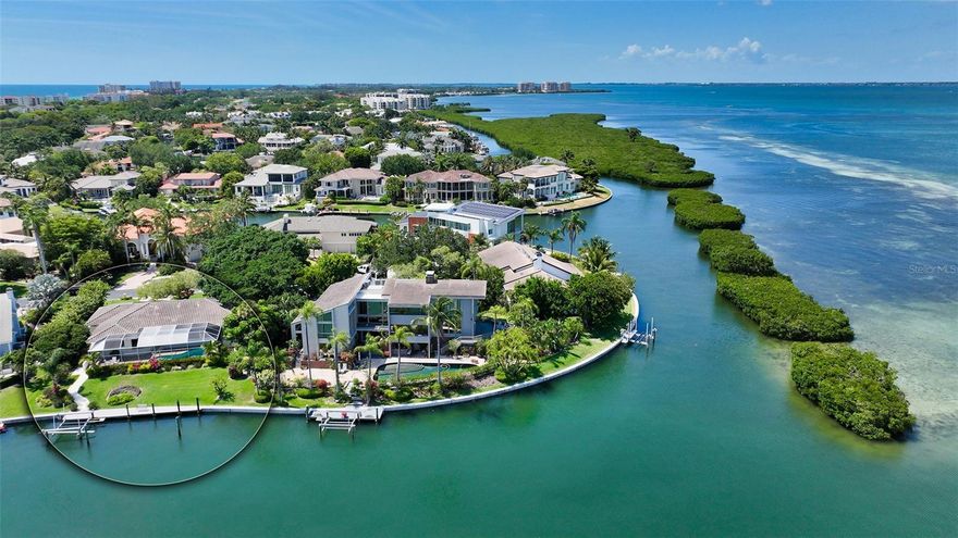 Build your dream home on this oversized waterfront lot in the exclusive gated neighborhood of Bay Isles Harbor Section!  This neighborhood definitely has the boater in mind.  The lot has approximately .38 acres and has 92 ft. of waterfront with a concrete seawall maintained by the HOA.  The property is second in from the bay and is on a deep wide canal that leads directly to the channel leading out to Sarasota Bay. Home is being torn down.