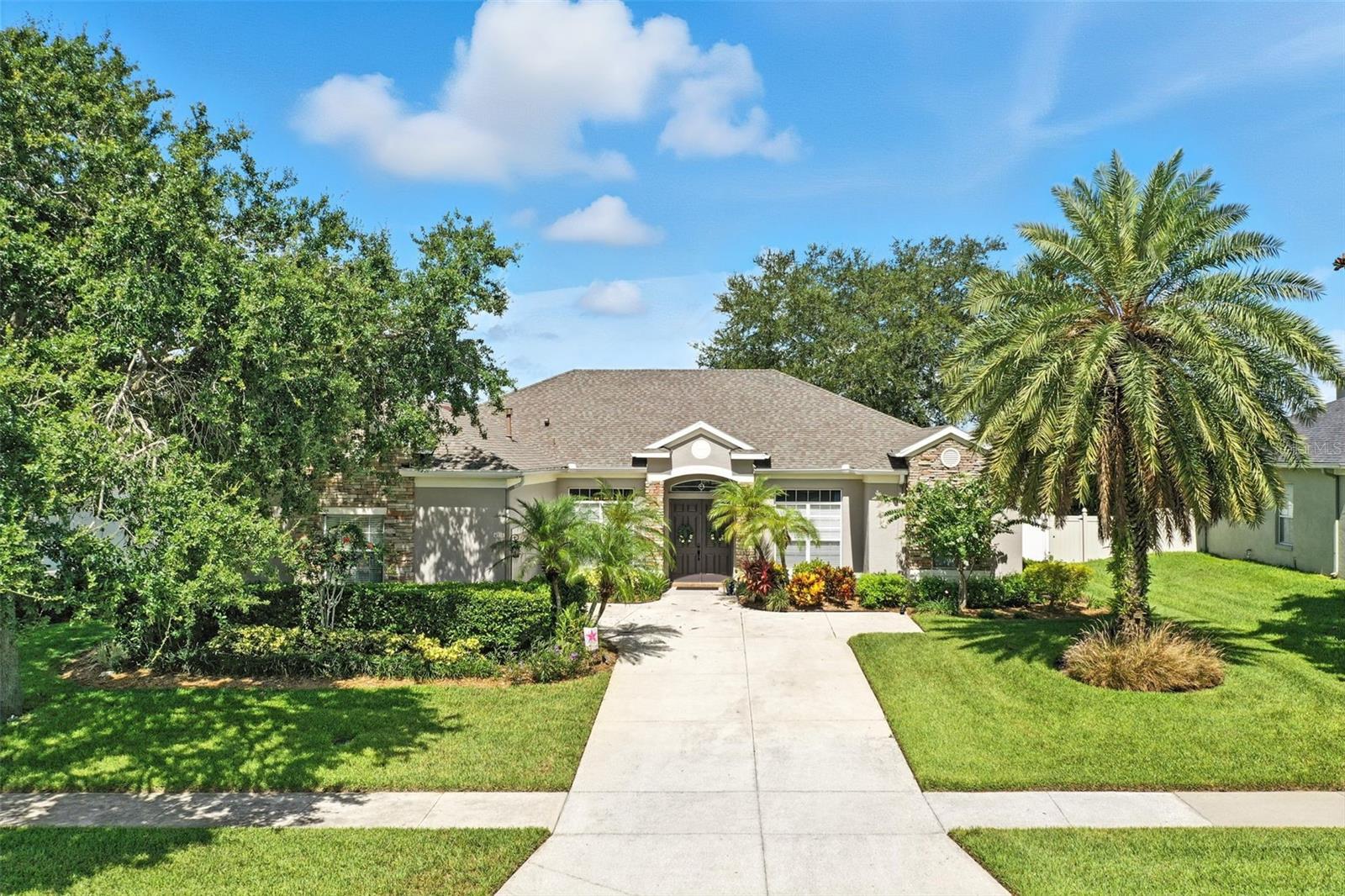 Step into this beautifully updated 4-bedroom, 3-bathroom home located in a gated community, offering both comfort and privacy. The layout is ideal for everyday living or hosting guests, with thoughtfully placed bedrooms and living spaces. At the front of the home, you'll find two full bedrooms and a full bathroom-perfect for guests, family, or a home office setup. On the opposite side, there’s another bedroom and full bathroom with convenient access to the screened lanai. Across the home, the spacious primary suite provides a peaceful retreat with tray ceilings, two closets, a private bath, and even a linen closet for added storage. The remodeled kitchen features granite countertops, new cabinets, and newer appliances-perfect for gathering with friends and family. Enjoy outdoor living in the large screened lanai with no rear neighbors, creating a private and relaxing space. Additional updates include a newer roof (2022), newer water heater (2023), and fresh interior and exterior paint. Ceiling fans in every bedroom add extra comfort, and the fully fenced yard is beautifully landscaped with citrus trees, flowering plants, and a sprinkler system to keep everything thriving. The gated community also offers fantastic amenities, including a beautiful community pool, basketball courts, tennis courts, and a playground area—providing something for everyone to enjoy. This is a rare opportunity to own a move-in ready, meticulously maintained home in a gated community that offers both style and a smart, functional layout.