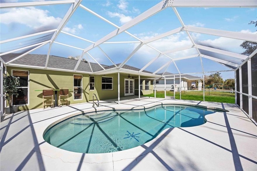 Welcome to this SPACIOUS 3-BEDROOM, 2-BATH, 2-CAR GARAGE CANAL-FRONT POOL HOME located in a NO FLOOD ZONE (X) in a quiet, sought after neighborhood with access to highly sought-after local schools. This beautifully maintained home is being sold furnished and features a NEWER ROOF (2023), HOT WATER HEATER (2024), POOL PUMP (2024), WELL PUMP (2024), and WATER SOFTENER (2024), along with VAULTED CEILINGS, a FULLY FENCED BACKYARD, and a CANAL-FRONT LOT, all within 1,623 sq. ft. of bright, open living space.
Inside, you’ll find laminate and tile flooring throughout and a spacious open layout. The kitchen offers granite countertops, stainless steel appliances, abundant cabinetry, and a breakfast bar overlooking kitchen and pool area—perfect for entertaining.
The generous primary suite features pool and lanai views, a walk-in closet, and a private ensuite with dual sinks, a soaking tub, and a walk-in shower. A split-bedroom floor plan provides privacy, with two additional bedrooms and a full guest bath.
Step outside to your covered lanai with screened pool, overlooking the fenced backyard with mature trees and peaceful canal views—a perfect space to relax or host guests.
Conveniently located near I-75, the Murdock shopping and restaurant district, hospitals, and everyday conveniences, this home truly offers comfort, privacy, and lifestyle.
We would love for you to tour this beautiful home—no obligation, just come see if it feels like the right fit!