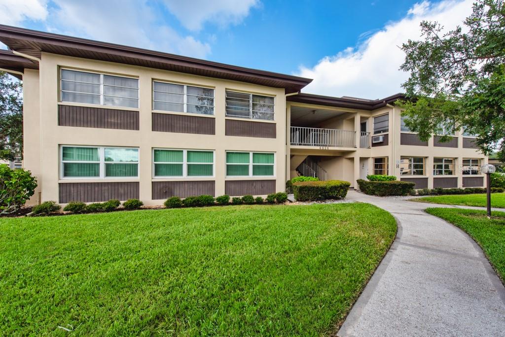 Soak up the Florida lifestyle in this spacious 2-bedroom, 2-bath condo located in the sought-after Gulf Harbors community in New Port Richey. Perched safely on the second floor and offering 1,312 square feet of comfortable living space, this bright and inviting unit is one of the larger floor plans in the community—giving you room to stretch out and make it your own. Inside, you’ll find a smart blend of tile and carpet flooring, an oversized primary suite with a private bath and walk-in closet, and sliding glass doors from both bedrooms and the main living area that open to a generous bonus room—perfect as a sunroom, office, or cozy second living area. A dedicated covered parking space is included, and the community laundry is conveniently located just below the unit on the first floor. Gulf Harbors offers more than just a home—it’s a lifestyle. The monthly HOA fee covers nearly everything: cable TV, high-speed internet, water, sewer, trash, exterior maintenance, building insurance, recreational facilities, and a community pool. All the essentials are taken care of so you can focus on enjoying the coastal breeze, friendly neighbors, and all that this vibrant waterfront community has to offer. Whether you're looking for a year-round residence, winter retreat, or weekend getaway, this condo delivers space, value, and peace of mind—all in one of the most desirable corners of New Port Richey.