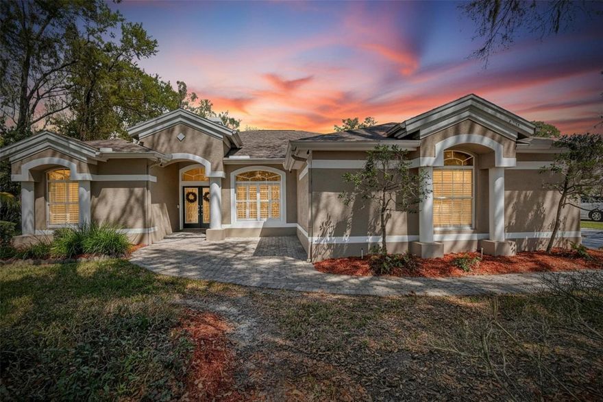 Welcome to this stunning Arthur Rutenberg custom home located in the highly sought-after 24/7 gated community of FishHawk Trails. Situated on a large executive homesite surrounded by nature, this exceptional property offers miles of walking trails, wide tree-lined streets, tennis and basketball courts, a community center, and is zoned for highly rated schools—creating the perfect setting for resort-style living every day.
This spacious home offers 5 bedrooms (or 4 bedrooms plus a bonus room), 4 bathrooms, a private office, and an impressive flex room addition that is currently a sports/game room, all centered around an incredible outdoor living space designed for relaxing and entertaining.
As you arrive, you’ll immediately notice the inviting pavered front entrance with a beautiful stone waterfall feature. Enter through the double beveled glass doors into the formal living room featuring a gas fireplace and views of the pool, along with a formal dining room and a private office with built-in cabinetry and double French doors.
The home features beautiful hardwood flooring along with luxury vinyl flooring added throughout the home. The chef’s kitchen is sure to impress with staggered wood cabinetry with crown molding, soft-close drawers, pull-out shelving, tile backsplash, granite countertops, and stainless steel appliances, including double wall ovens, cooktop, convection microwave and dishwasher.
The spacious family room showcases the signature Arthur Rutenberg ceiling detail and built-in shelving while opening seamlessly to the outdoor living area through triple pocket sliding glass doors.
The private primary suite is tucked away off the formal living areas and features French doors leading to the pool area, dual walk-in closets, and an elegant spa-style bathroom.
The thoughtfully designed floor plan offers two additional bedrooms and a bathroom near the kitchen and family room, while a fourth bedroom and the fifth bedroom or bonus room are located on the opposite side of the home, overlooking the peaceful wooded backyard. The nearby third bathroom also serves as a convenient pool bath.
The outdoor living space is truly the heart of this home, featuring a beautiful pool and spa, a fully equipped outdoor kitchen, and plenty of space to relax or entertain. Beyond the pool area is a large flex room addition, perfect for a game room, entertainment space, home gym, or additional living area. Adjacent to the flex room is a cozy sitting area and a large air-conditioned storage room.
Additional highlights include:
* New roof installed in 2024
* Luxury vinyl flooring added throughout much of the home
* Oversized 3-car garage
* Private irrigation well to reduce water costs
* Electrical panel wired for a generator (generator included)
* Spacious laundry room 
* Built-in cabinetry and utility sink
* Abundant storage throughout the home
This exceptional property truly offers the perfect combination of luxury, space, functionality, and lifestyle in one of the area's most desirable gated communities.
Schedule your private showing today to experience everything this remarkable home has to offer.